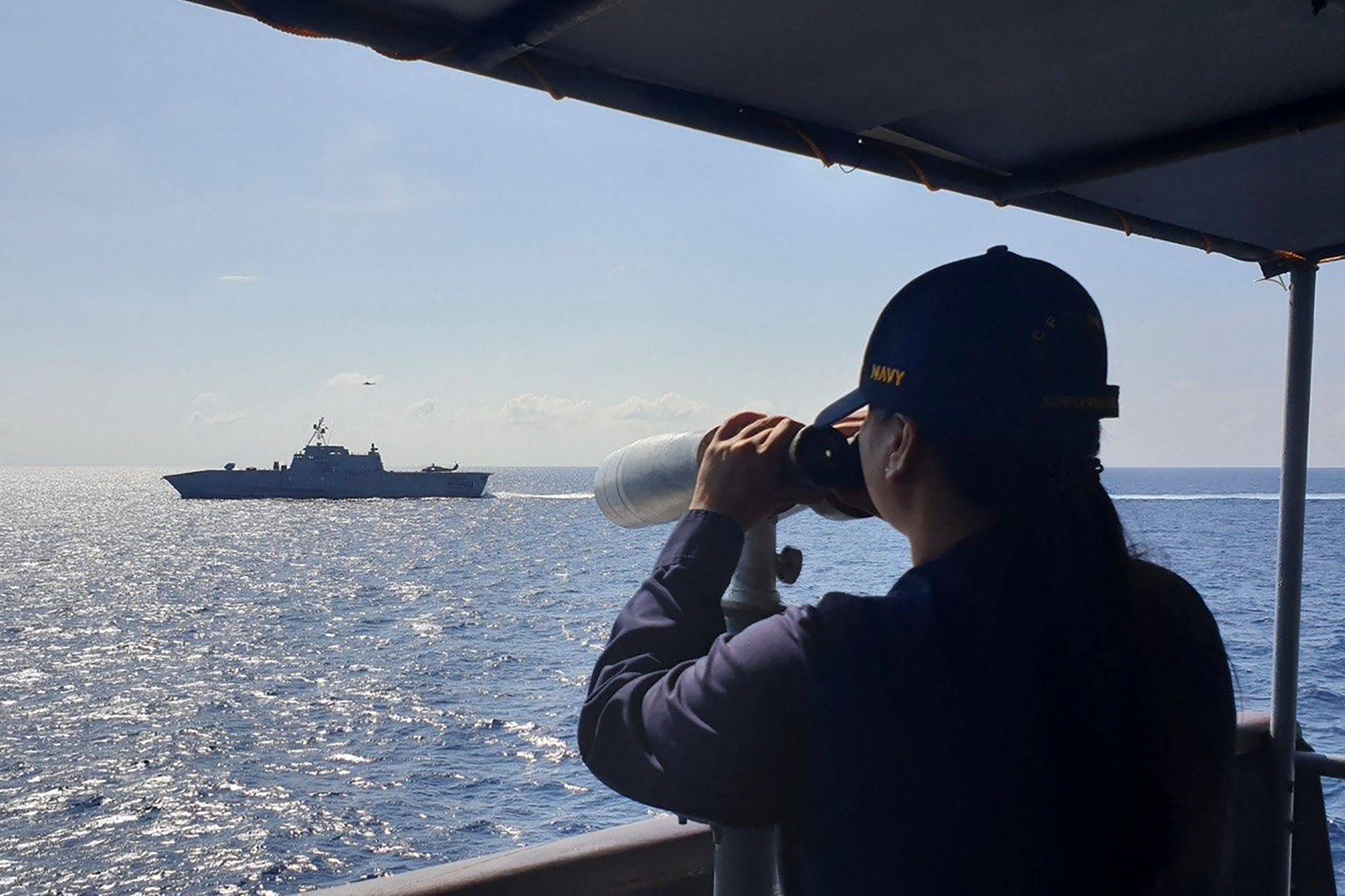A service member from the Philippine Navy keeps watch as a US littoral combat ship sails past during a joint “maritime cooperative activity” in the South China Sea on February 9. Photo: Armed Forces of the Philippines’ Western Command / Handout via AFP