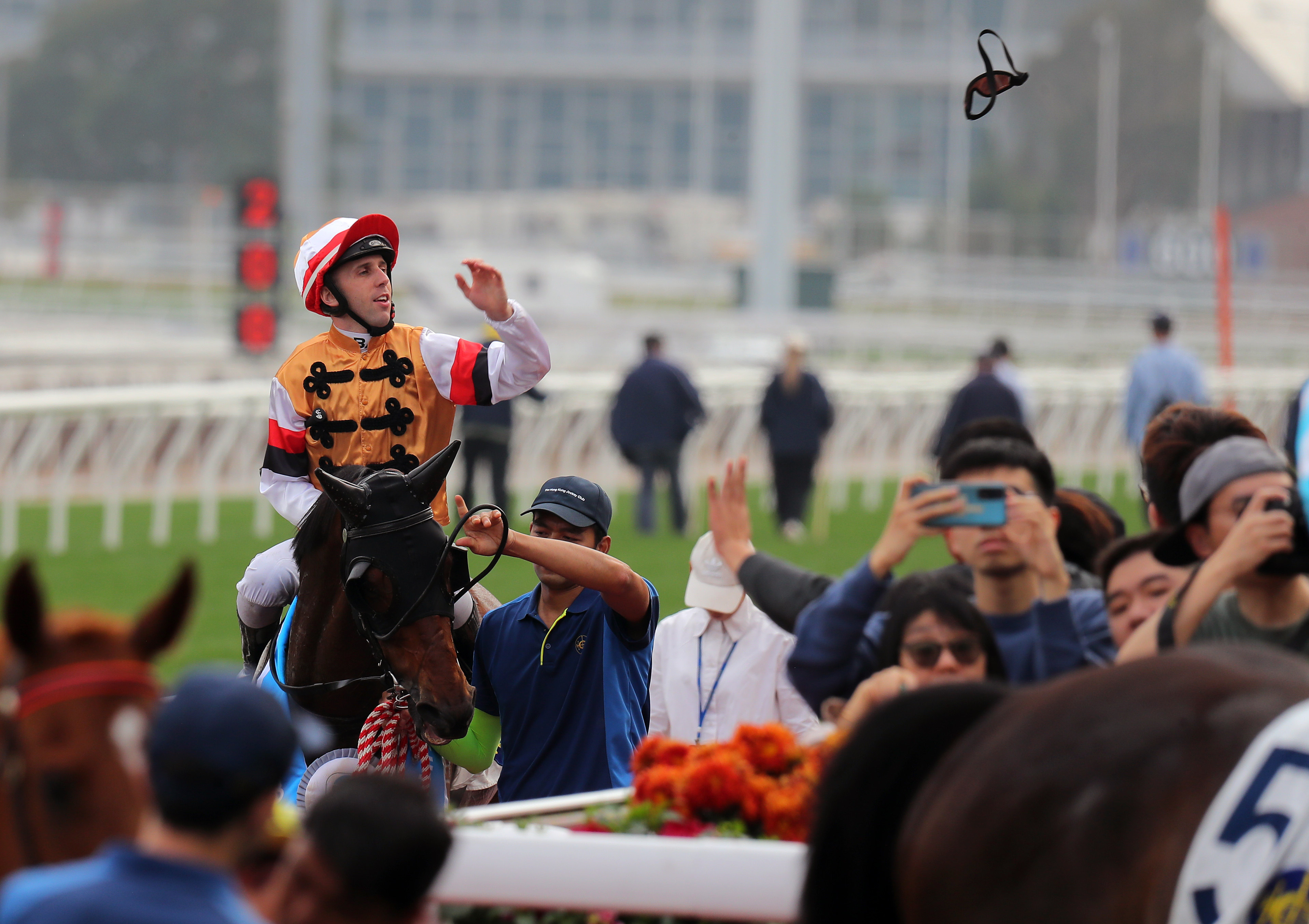 Jockey Brenton Avdulla sends his goggles into the crowd after saluting aboard Atullibigeal. Photos: Kenneth Chan