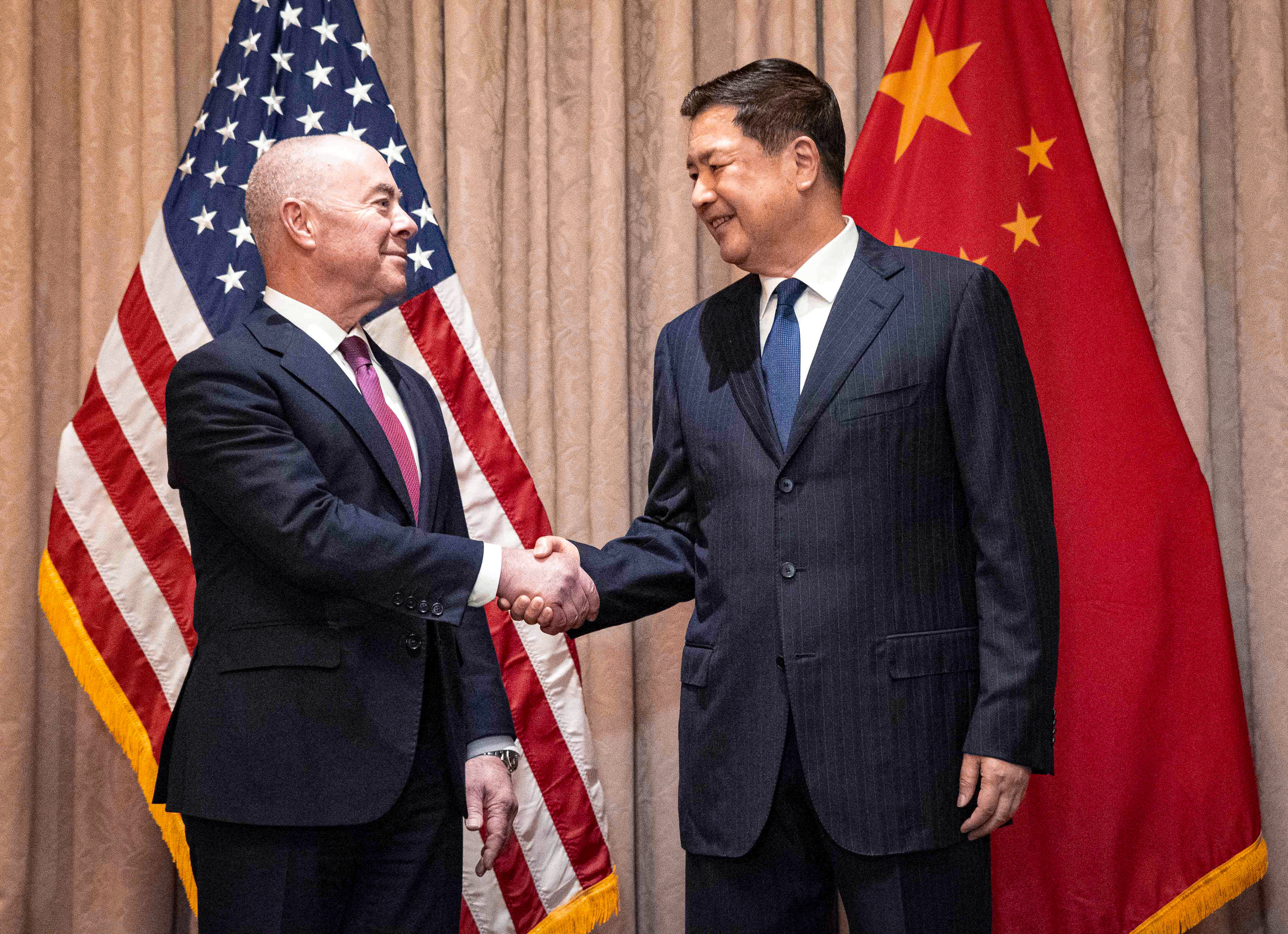 Chinese Public Security Minister Wang Xiaohong and US Homeland Security Secretary Alejandro Mayorkas greet each other in Vienna, Austria, on Sunday. Photo: AFP