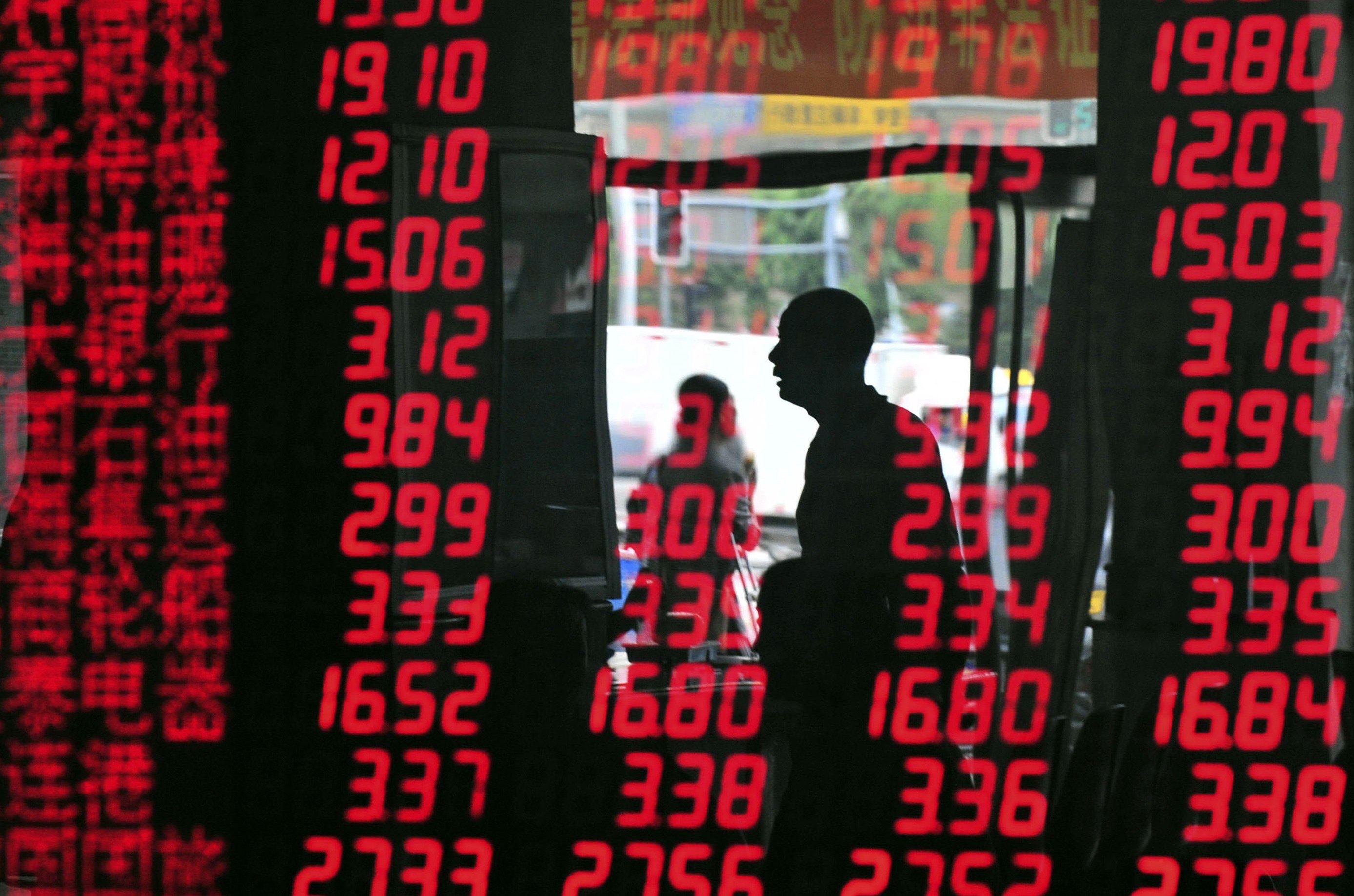 An investor is reflected in a screen showing stock information at a brokerage in Shenyang. Chinese stocks reopened higher after a week-long Lunar New Year holiday. Photo: Reuters