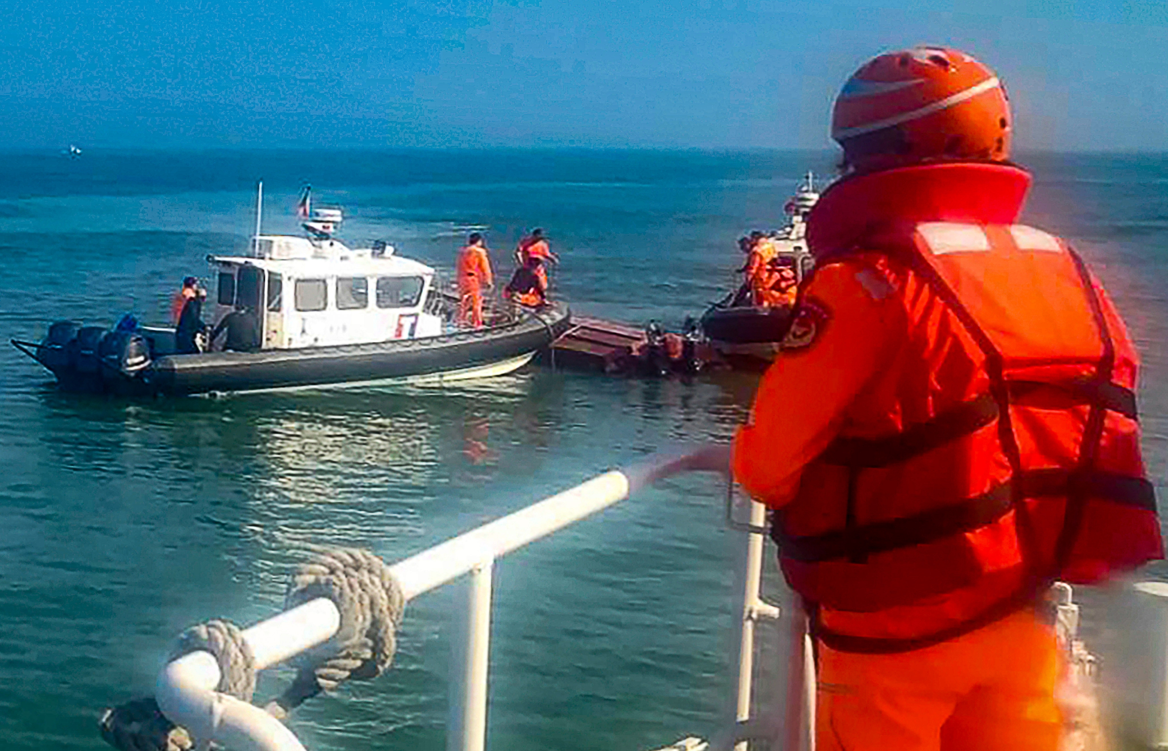 Taiwanese coast guards inspect a vessel that capsized during a chase off the coast of Kinmen archipelago on February 14. Photo: Taiwan Coast Guard Administration via AP
