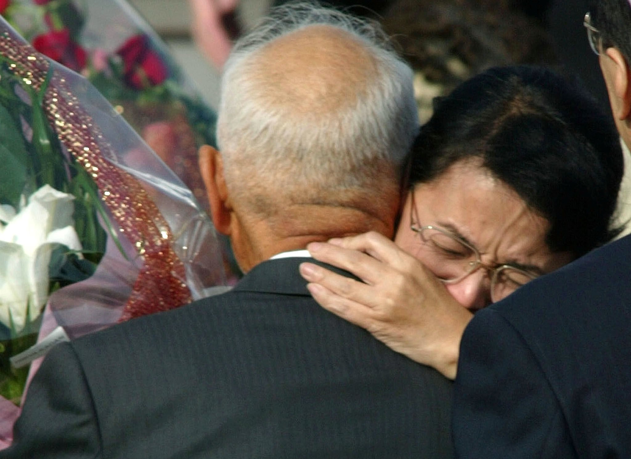 Fukie Hamamoto, abducted by North Korea 25 years ago, hugs her brother upon her return to Japan in 2002. Photo: Reuters