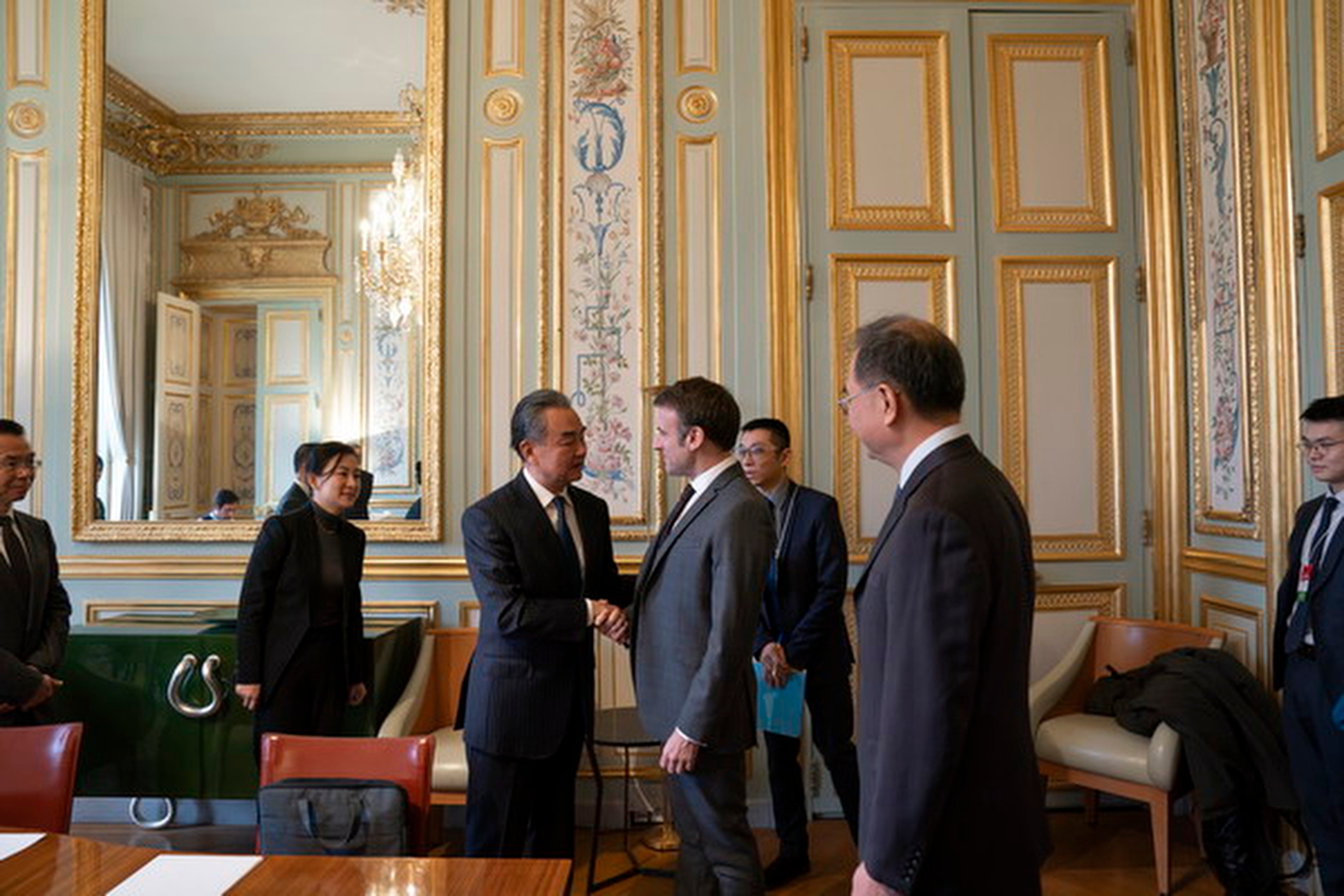 Chinese Foreign Minister Wang Yi (centre, left) shakes hands with French President Emmanuel Macron during talks in Paris on Tuesday. Photo: mfa.gov.cn