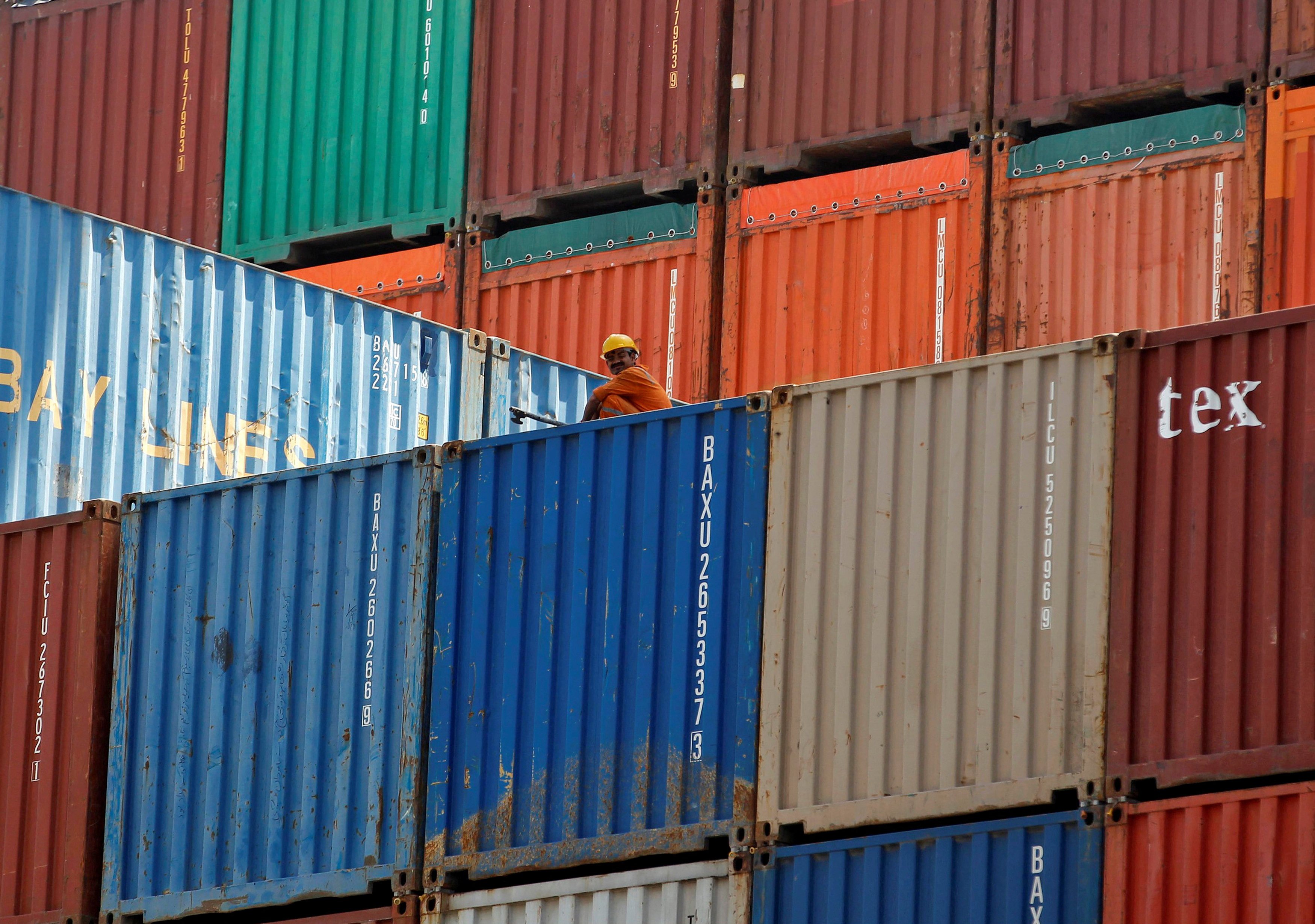 A worker sits on a ship carrying containers at Mundra port in the western Indian state of Gujarat. The European Union is mulling sanctions on Chinese and Indian firms’ export of electronics to Russia. Photo: Reuters