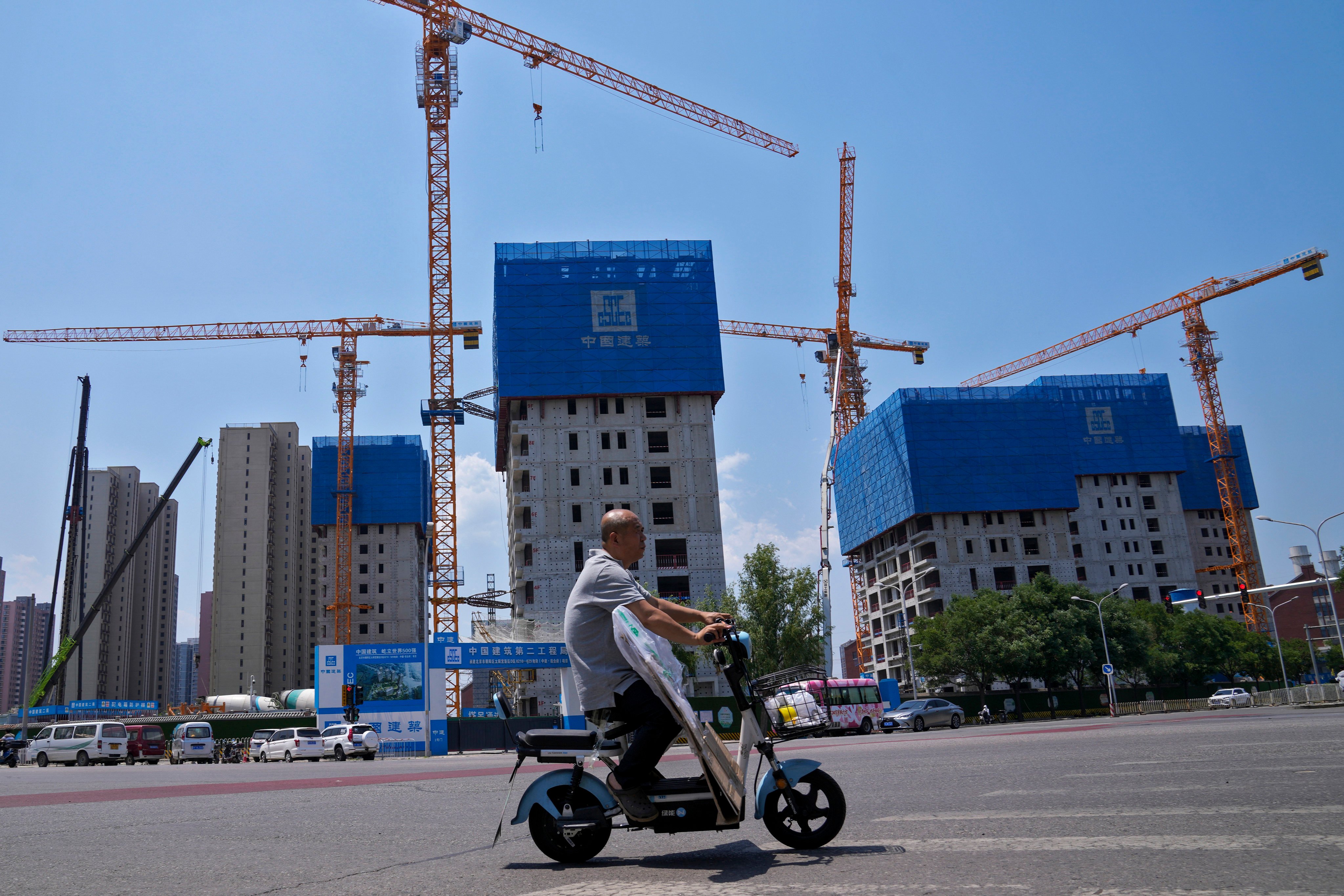 Residential buildings under construction in Beijing. As of June last year, its total loans amounted to 27.39 billion yuan, dominated both in the yuan and US dollars, Sunshine 100 says. Photo: AP