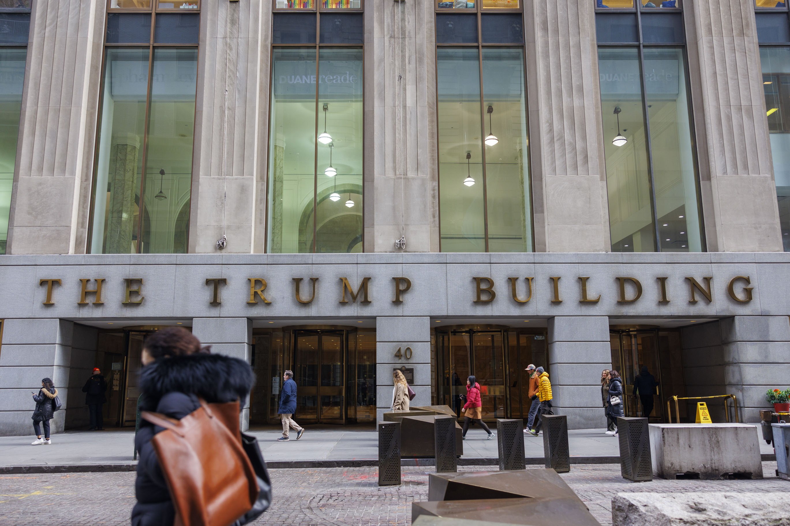 People walk in front of the Trump Building on 40 Wall Street in New York. Photo: EPA-EFE