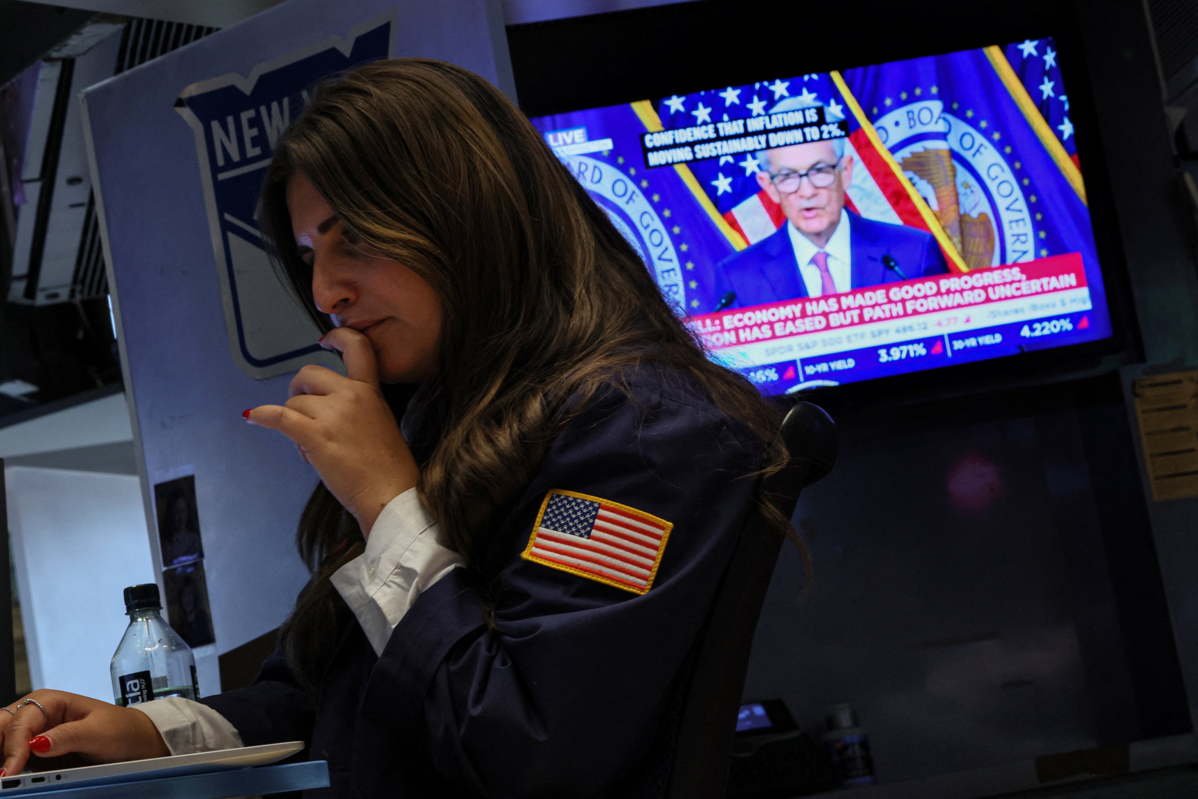 A trader works, as a screen displays a news conference by Federal Reserve chairman Jerome Powell following the central bank’s interest rate announcement, on the floor of the New York Stock Exchange on January 31. Photo: Reuters 