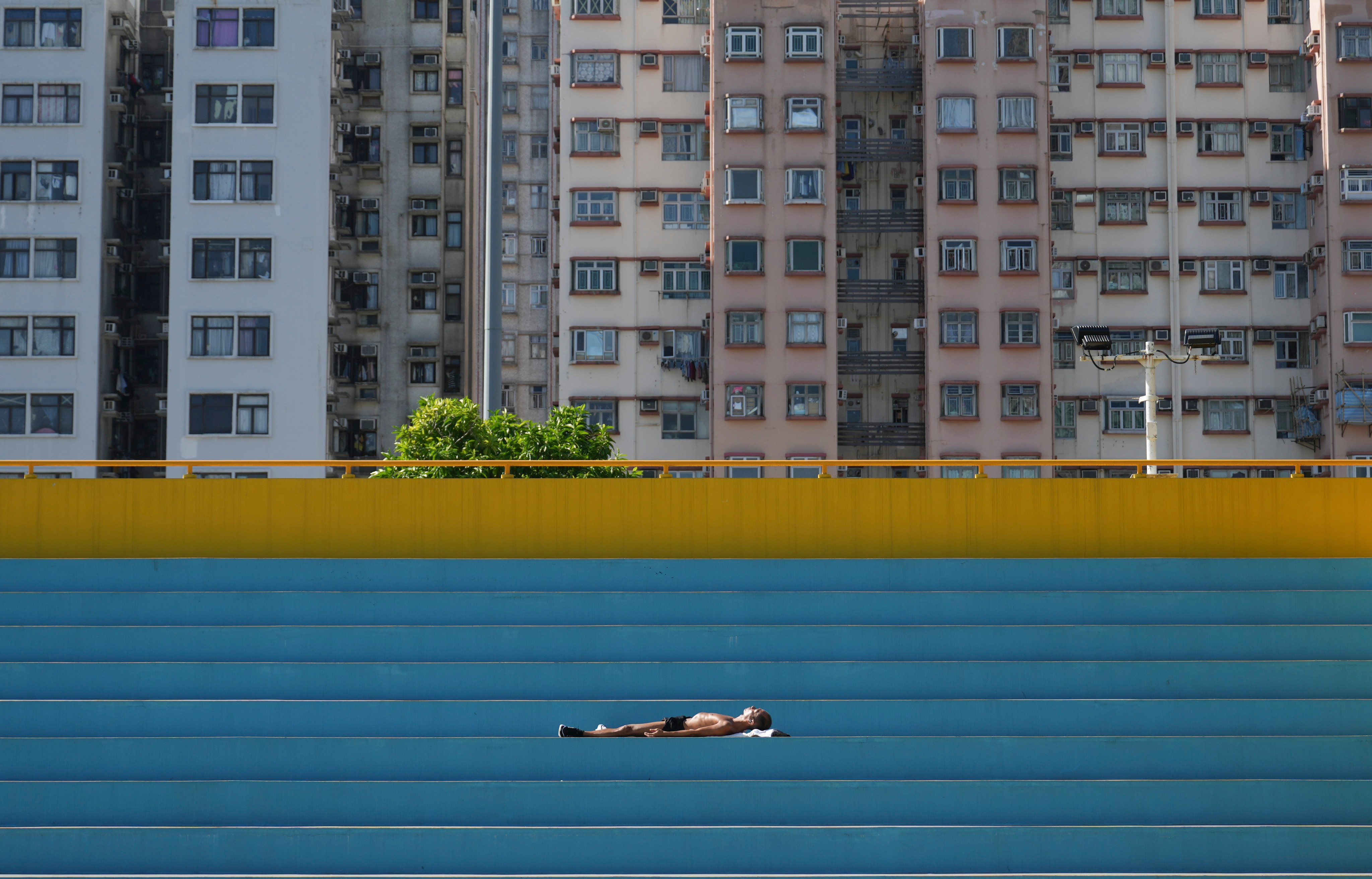 A man sunbaths in Hong Kong’s To Kwa Wan Recreation Ground. As the world continues to recover from the coronavirus pandemic, the outlook for Hong Kong’s property sector remains cloudy. Photo: Sam Tsang