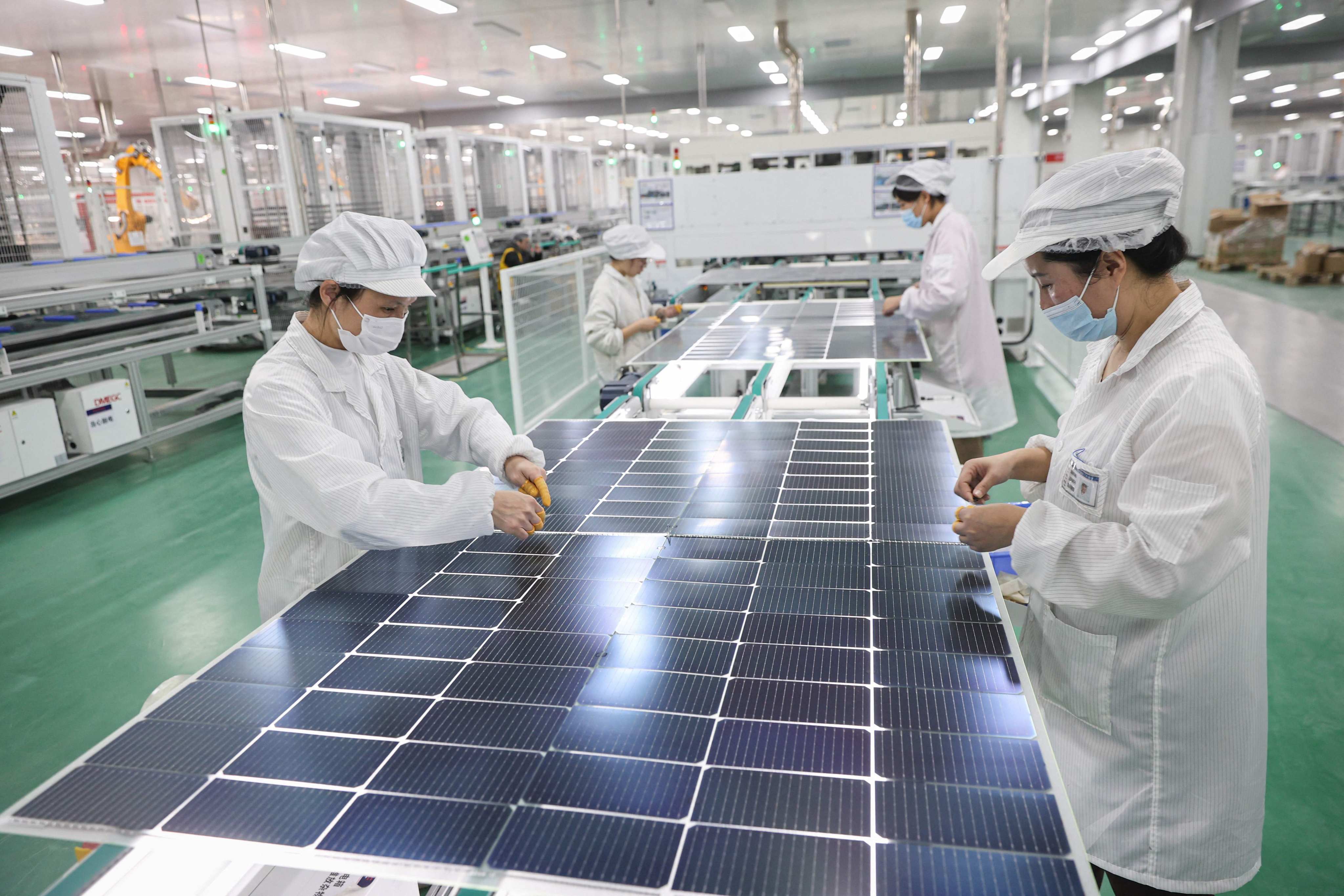 Chinese state media is calling on the nation’s banks to offer more support for green development, which includes renewable-energy sectors that produce goods such as solar panels (pictured). Photo: AFP