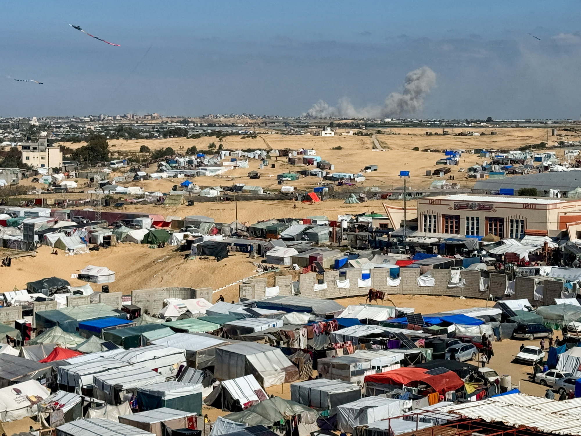 Smoke rises from Khan Younis, as seen from a tent camp sheltering displaced Palestinians in Rafah, in the southern Gaza Strip. Photo: Reuters