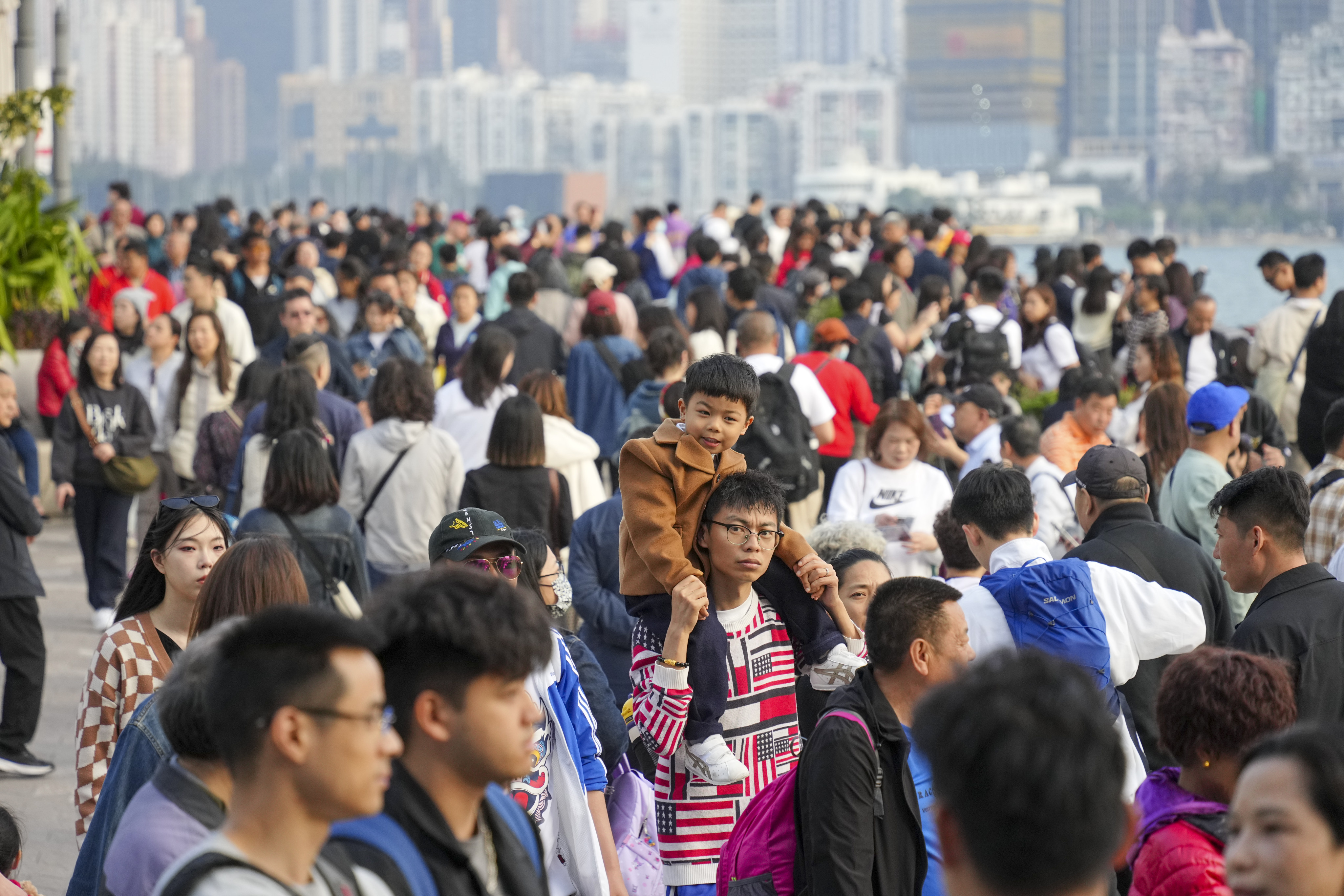 Tourists and residents at the Tsim Sha Tsui Waterfront during the Lunar New Year holiday. Photo: Eugene Lee