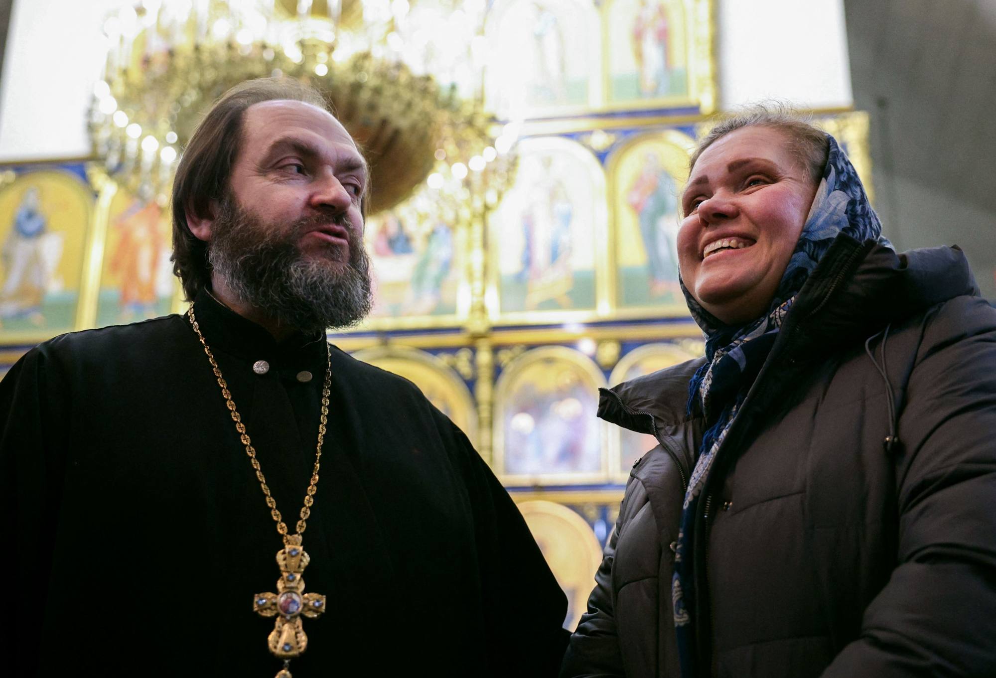Ukrainian Orthodox priest Oleg Kruchinin and his wife Olga Kruchinina pose at a church in Kramatorsk, Donetsk region. Photo: AFP