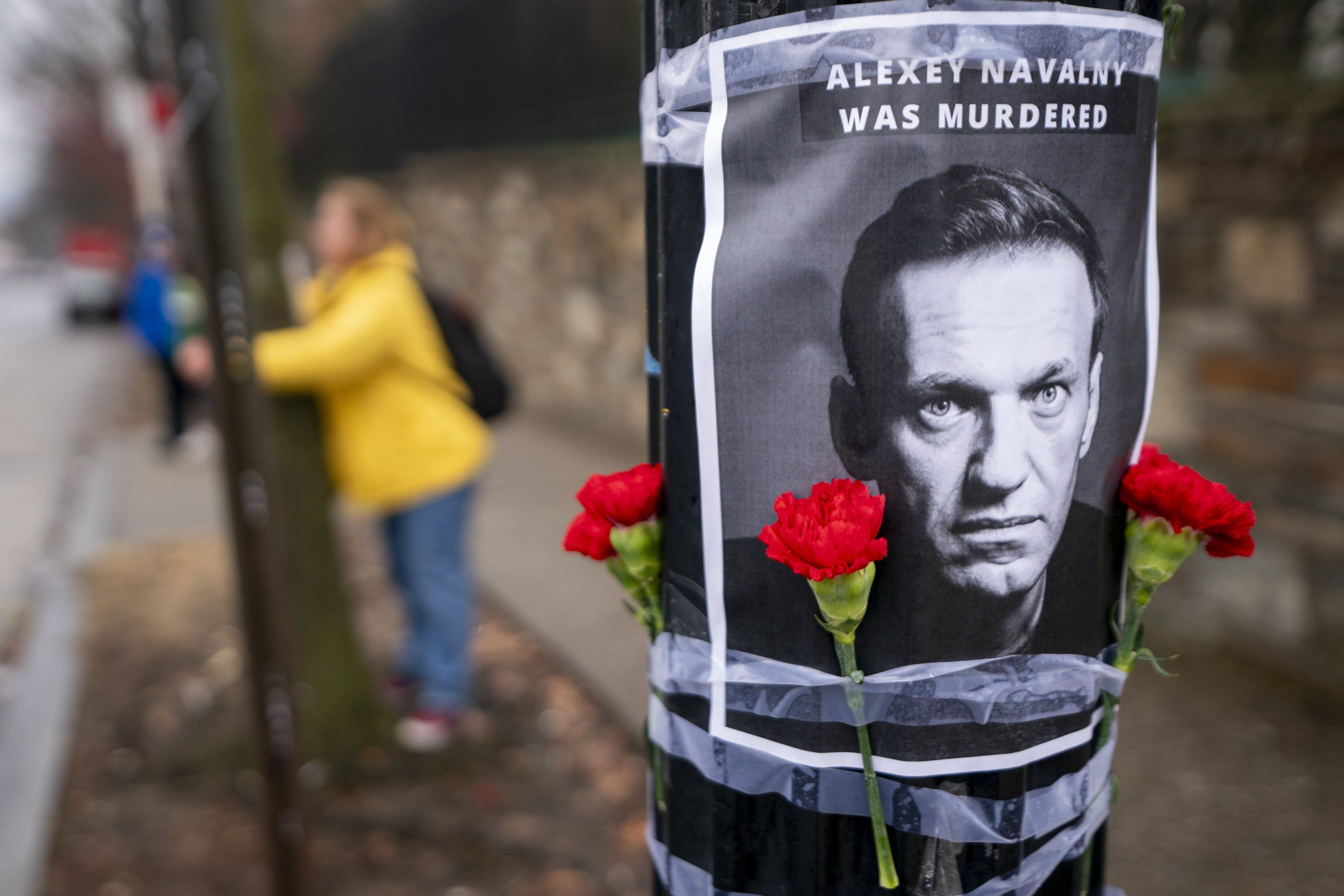 A Russian woman tends a memorial for Alexei Navalny outside the Russian Federation embassy in Washington on Friday. Photo: EPA-EFE