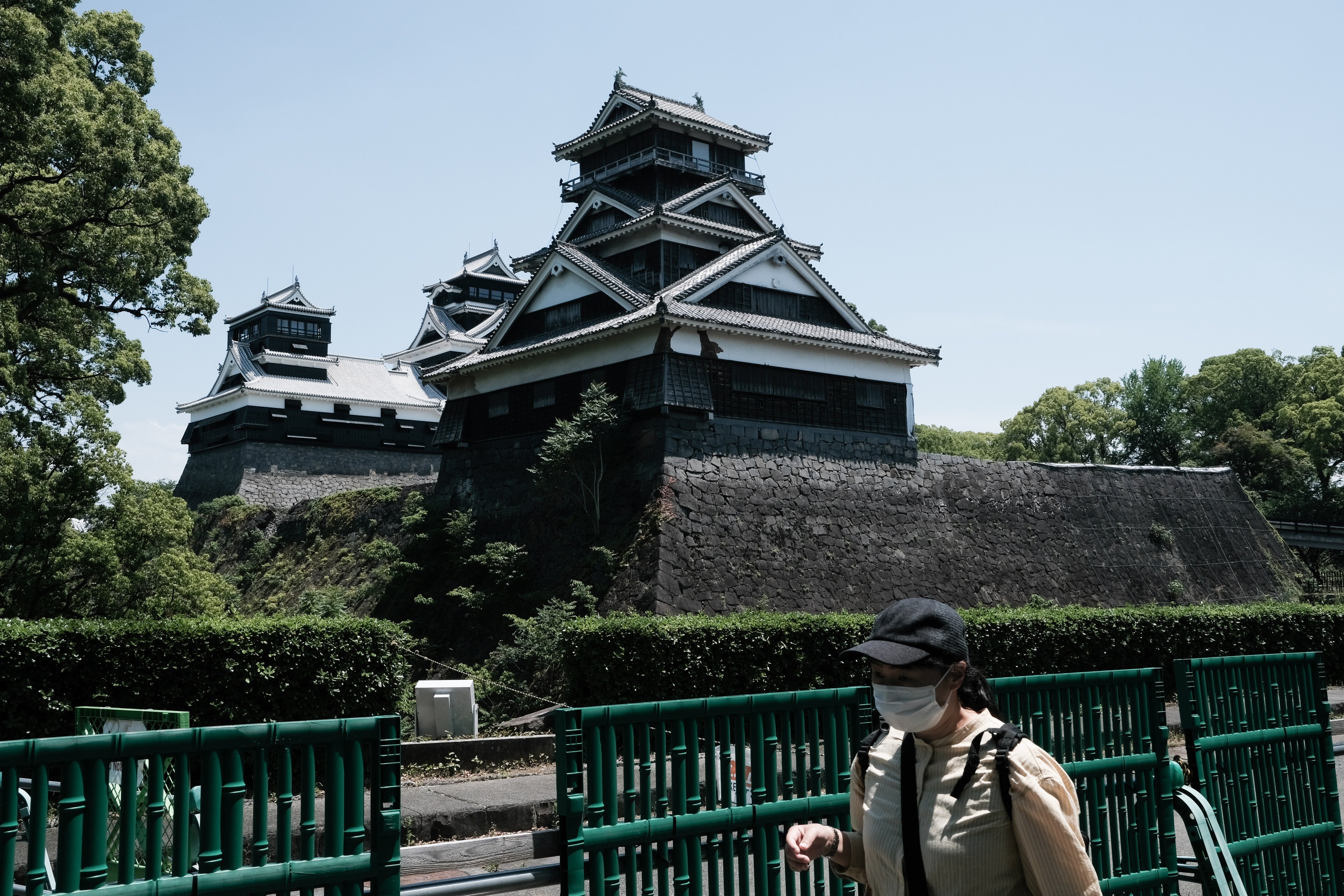 A visitor walks in front of the Kumamoto Castle in Japan. Photo: Bloomberg
