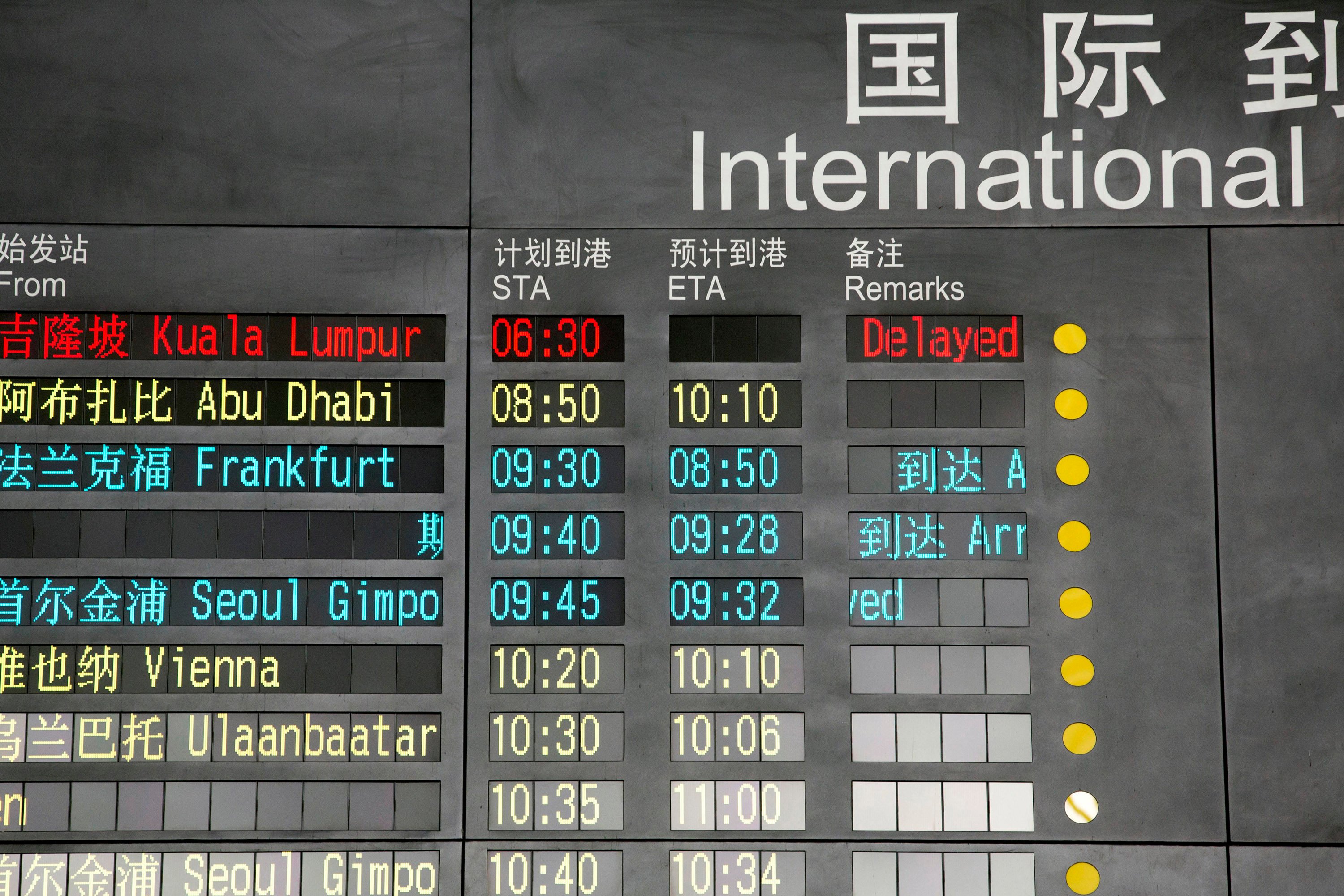 The arrival board at the International Airport in Beijing, China, shows a Malaysian airliner delayed on March 8, 2014. Photo: AP