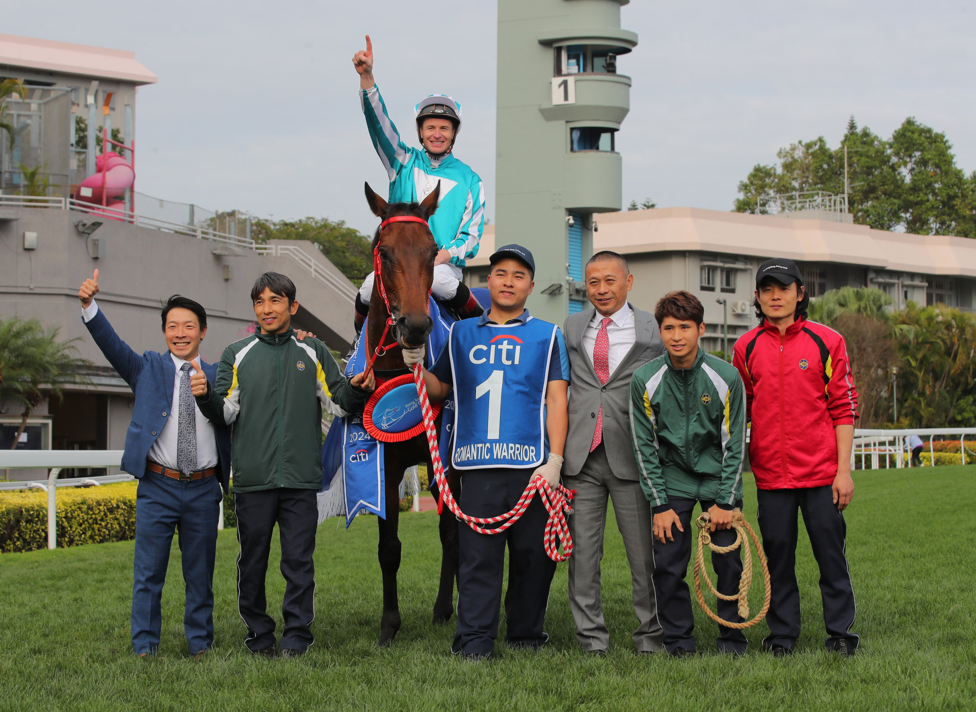 Jockey James McDonald, trainer Danny Shum and stable staff celebrate Romantic Warrior’s Gold Cup win.