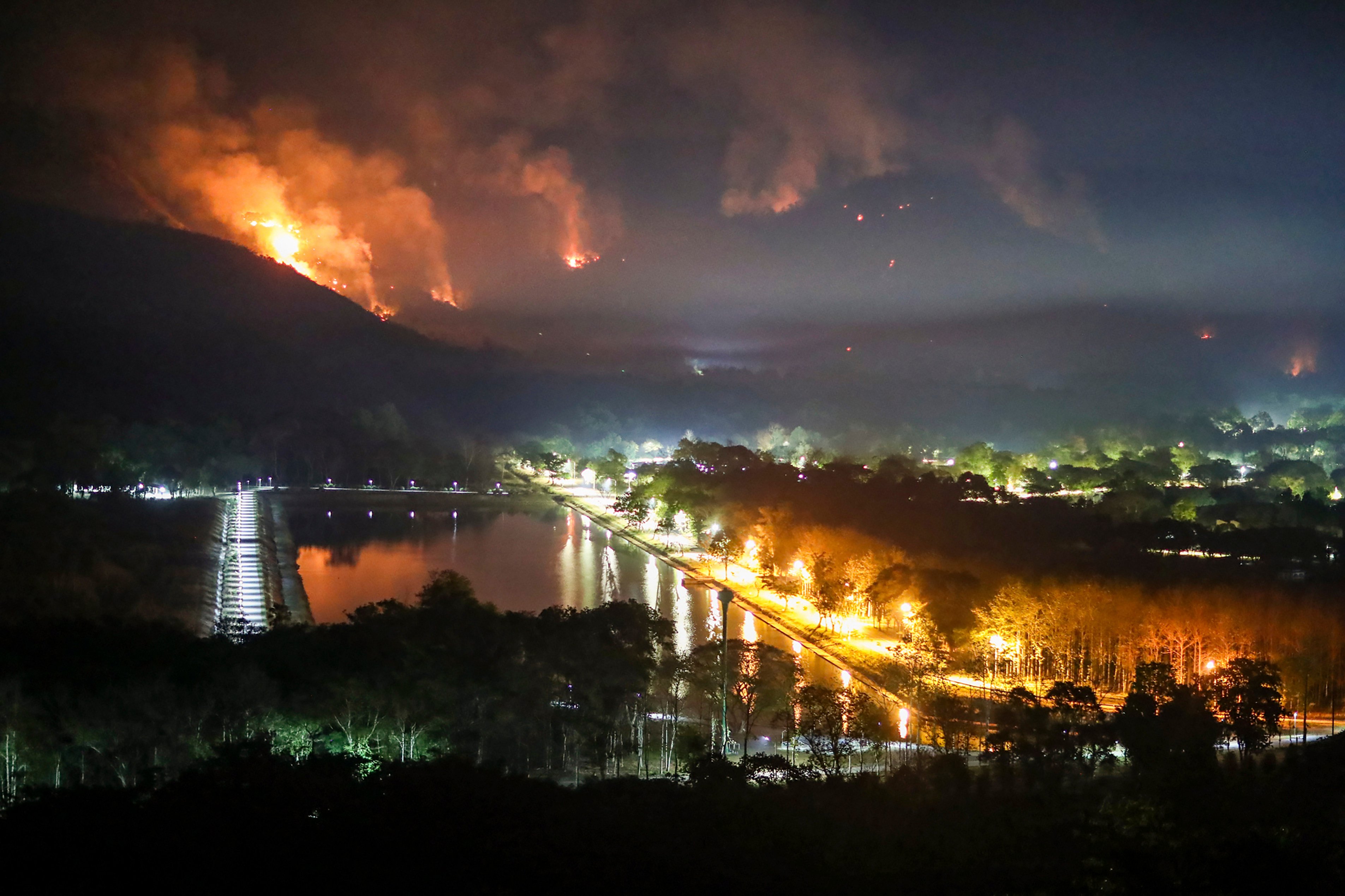Fire and smoke rise from a forest fire at Nakhon Nayok province province in Thailand on March 30, 2023. The Asia-Pacific is uniquely vulnerable to the effects of climate change, making Hong Kong’s role as a hub for green finance and investment all the more important. Photo: AP