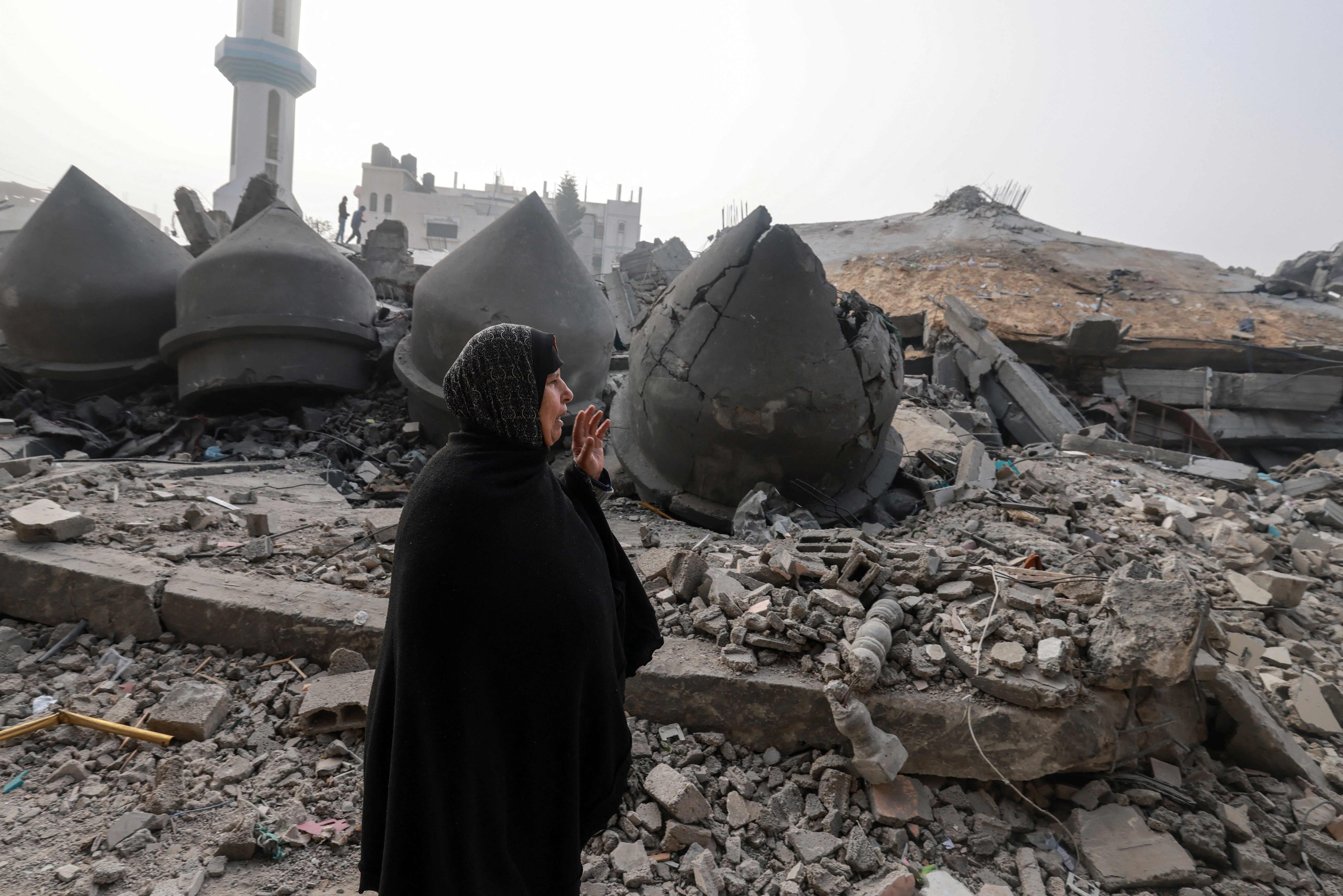 A woman walks near the Al-Faruq mosque, levelled by Israeli bombardment in Rafah in the southern Gaza Strip. Photo: AFP