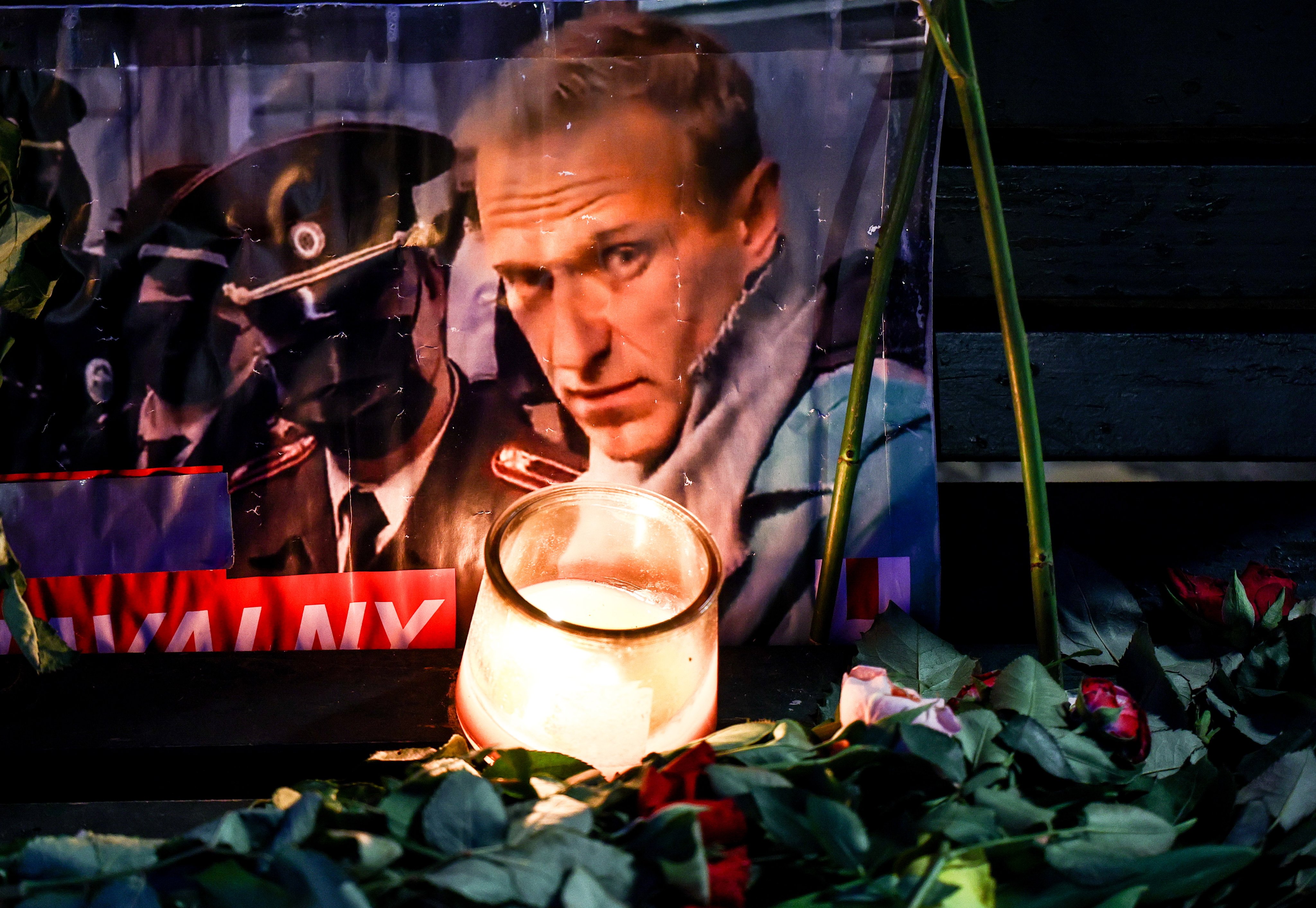 A portrait of late Russian opposition leader Alexei Navalny sits among floral tributes and a candle outside the Russian embassy in Berlin. Navalny’s ally Maria Pevchikh said she had confirmation that negotiations for the swap were in their final stages on the evening of February 15. Photo: EPA-EFE