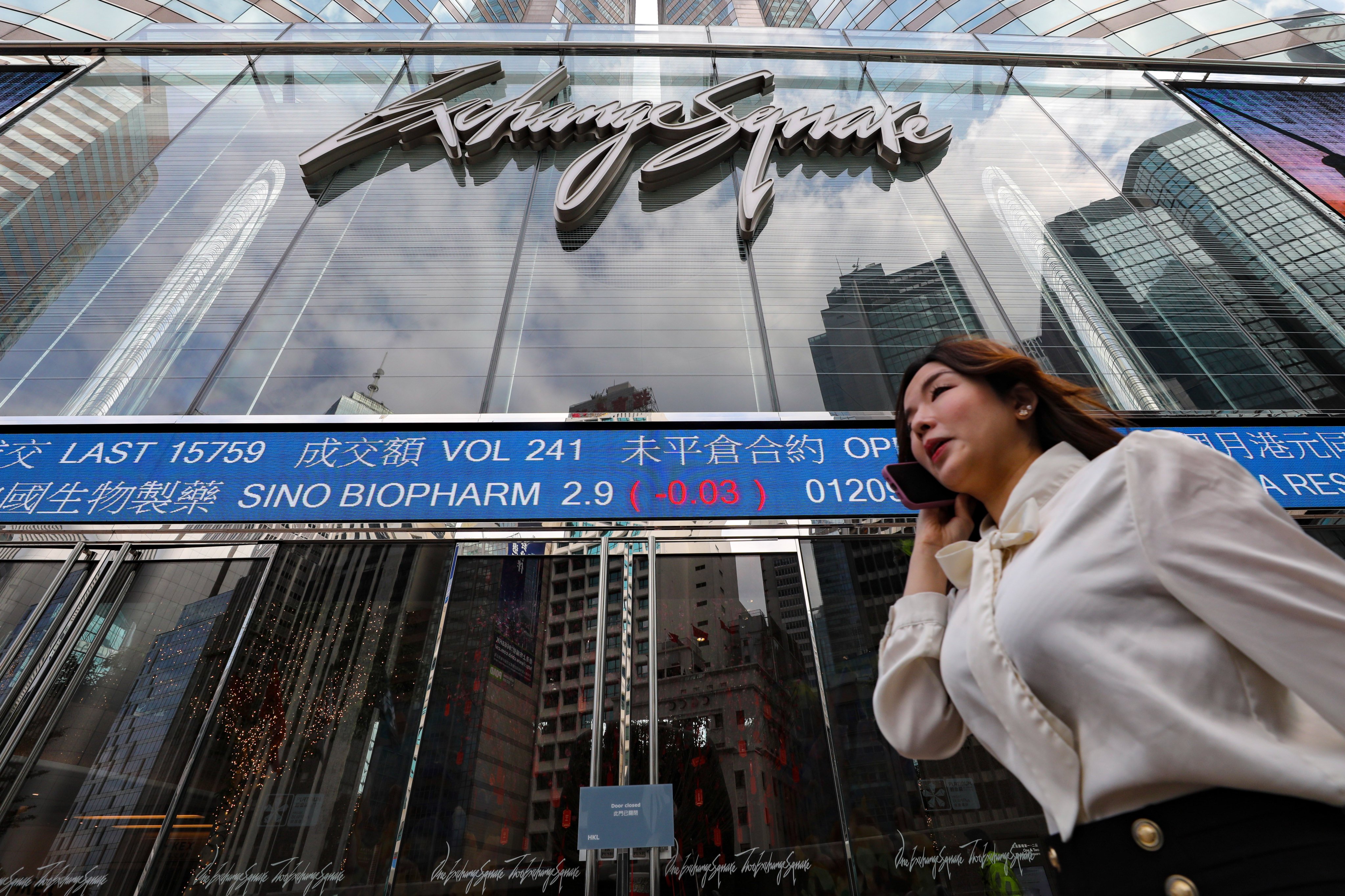 Screens showing the index and stock prices outside Hong Kong Exchange Square. Photo: Sun Yeung