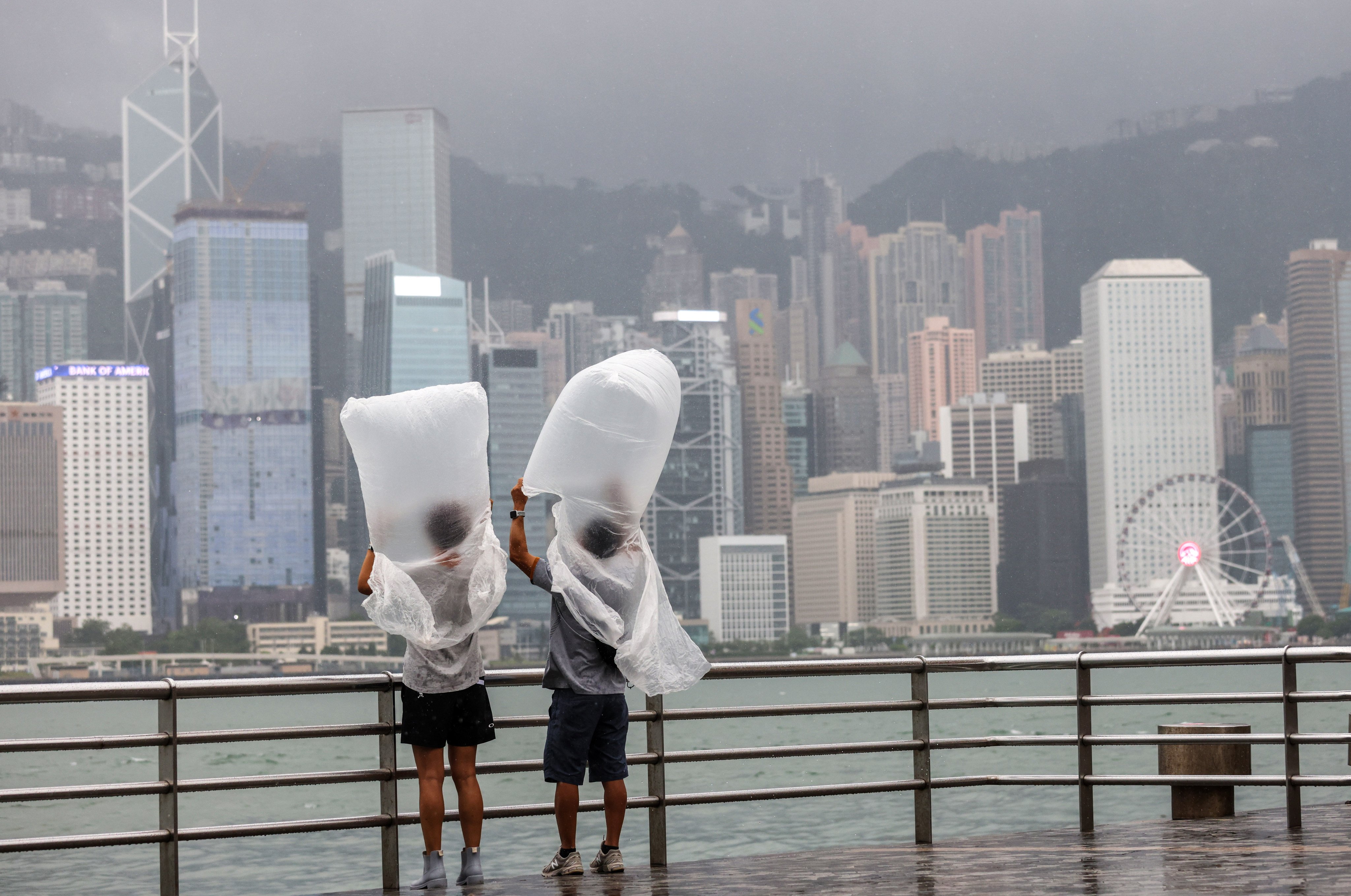 People at the Tsim Sha Tsui promenade feel the effects of Typhoon Saola on September 1, 2023. As extreme weather becomes more frequent around the world, pressure on businesses to reduce carbon emissions has grown. Photo: Yik Yeung-man