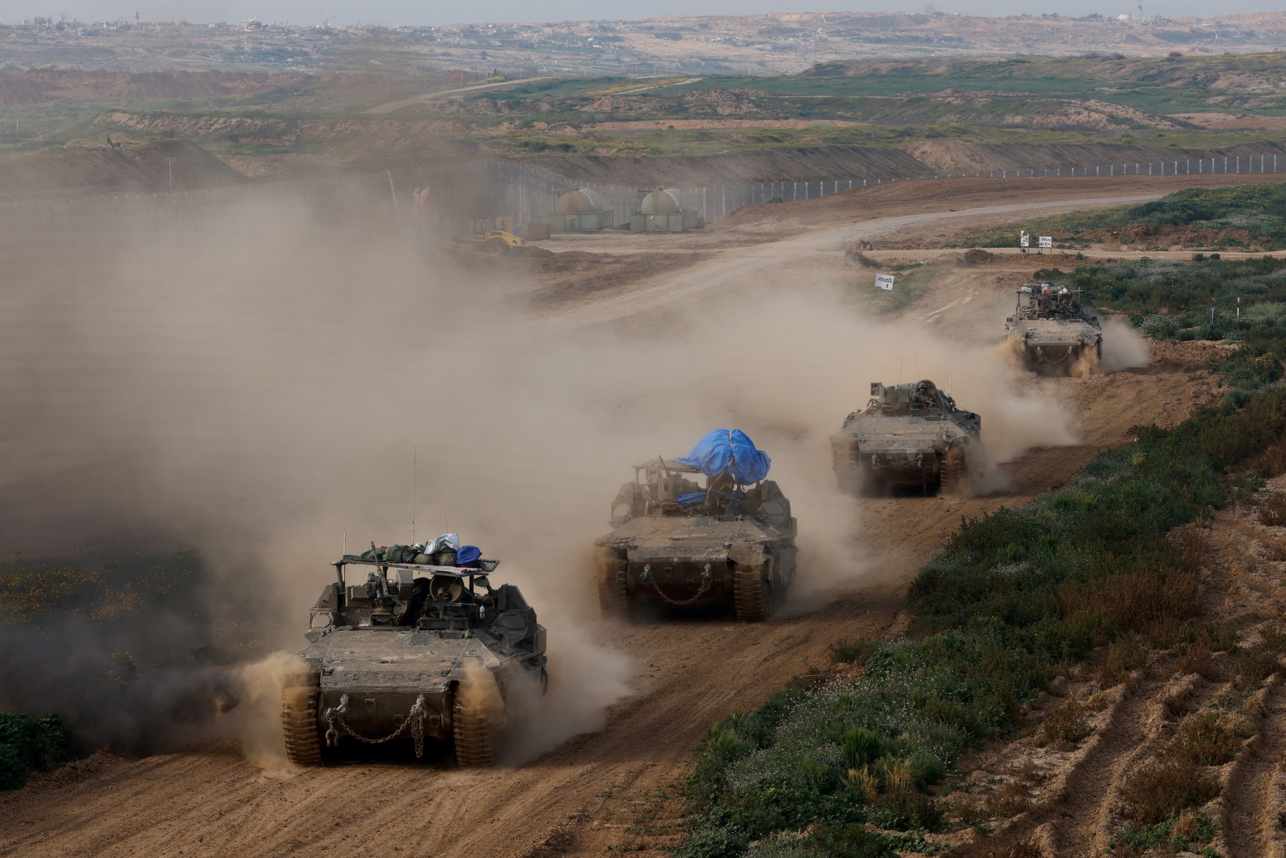 Israeli army vehicles return from the southern Gaza strip, in southern Israel. Photo: Reuters