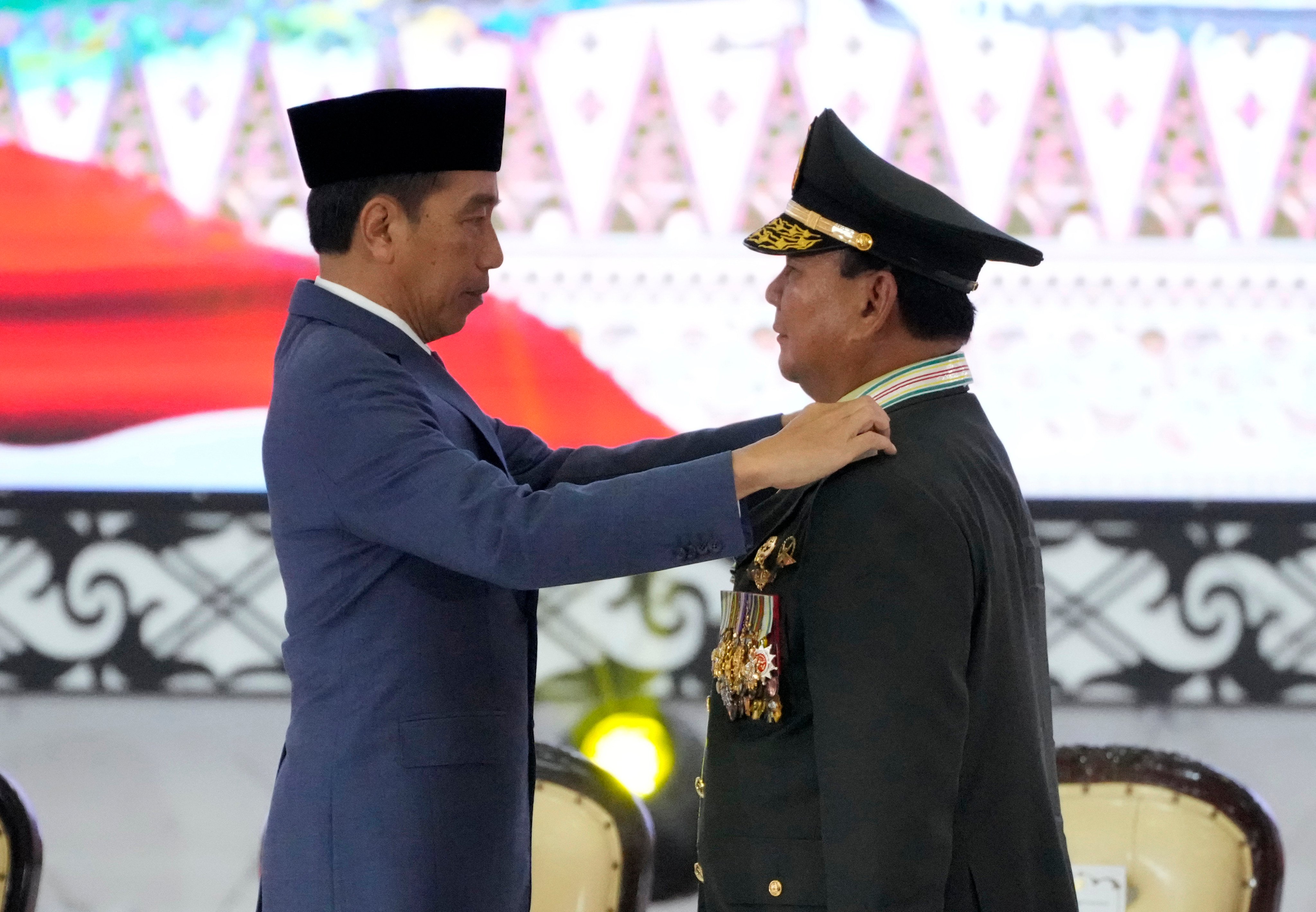 Indonesian Defence Minister Prabowo Subianto, right, receives four-star general epaulettes from President Joko Widodo on Wednesday. Photo: AP