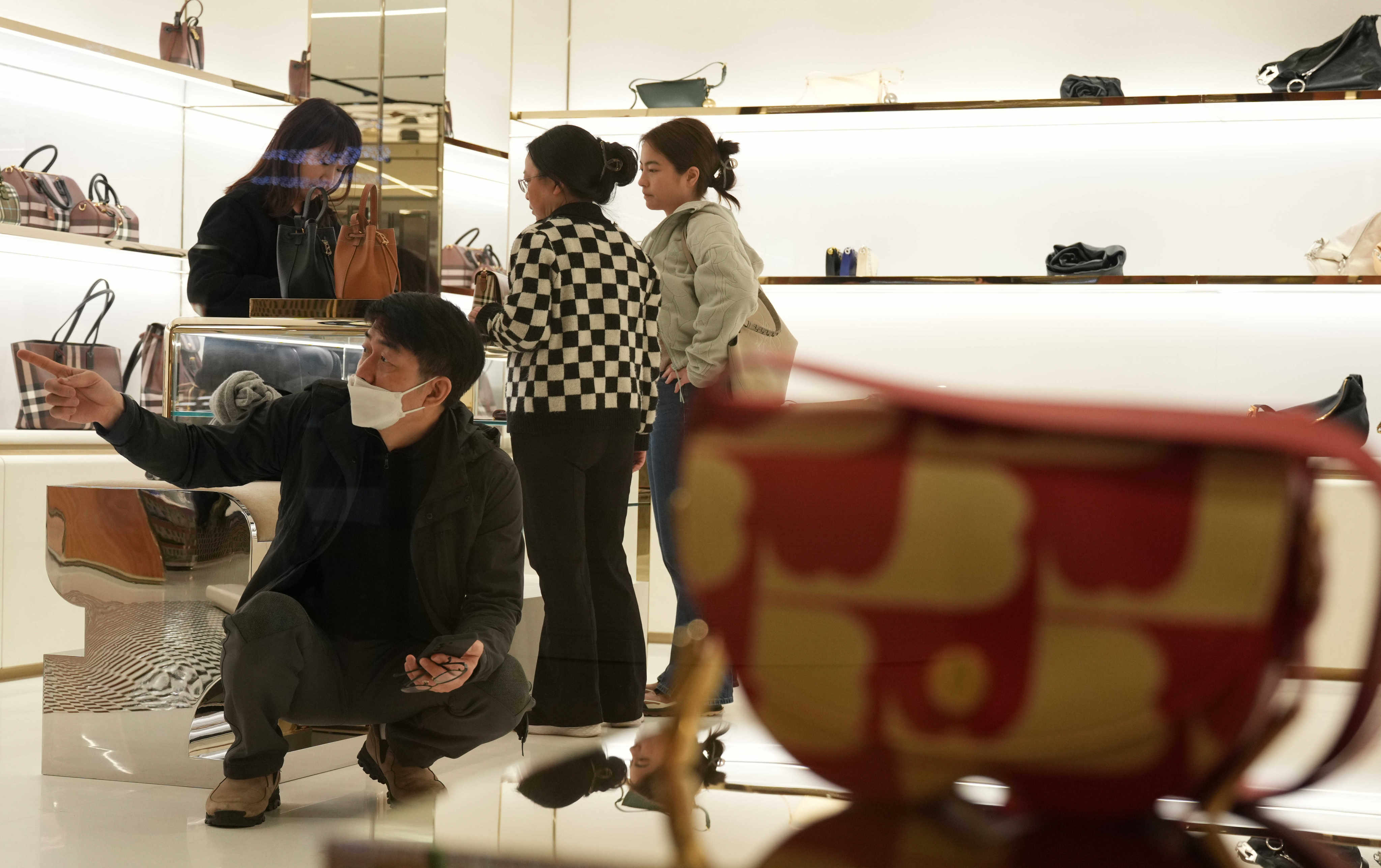 Tourists shop at a luxury store in Admiralty on February 11, over Lunar New Year. With a sluggish world economy, it isn’t a good sign if Hong Kong is still known to be an expensive city. Photo: Eugene Lee 