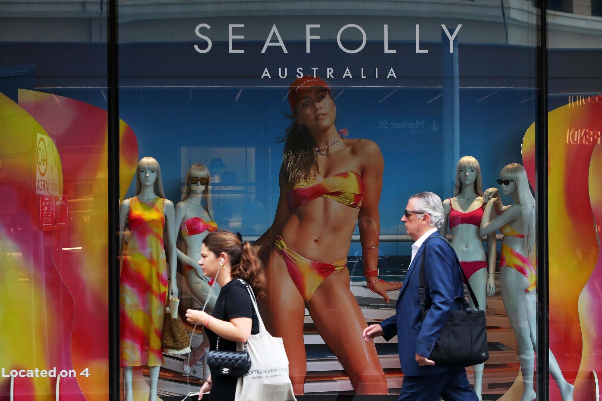Pedestrians pass a Seafolly store in the central business district in Sydney on February 6. Australia’s central bank kept interest rates unchanged at its first meeting of a revamped policy schedule and signalled further tightening remains possible, sending the currency and bond yields higher. Photo: Bloomberg