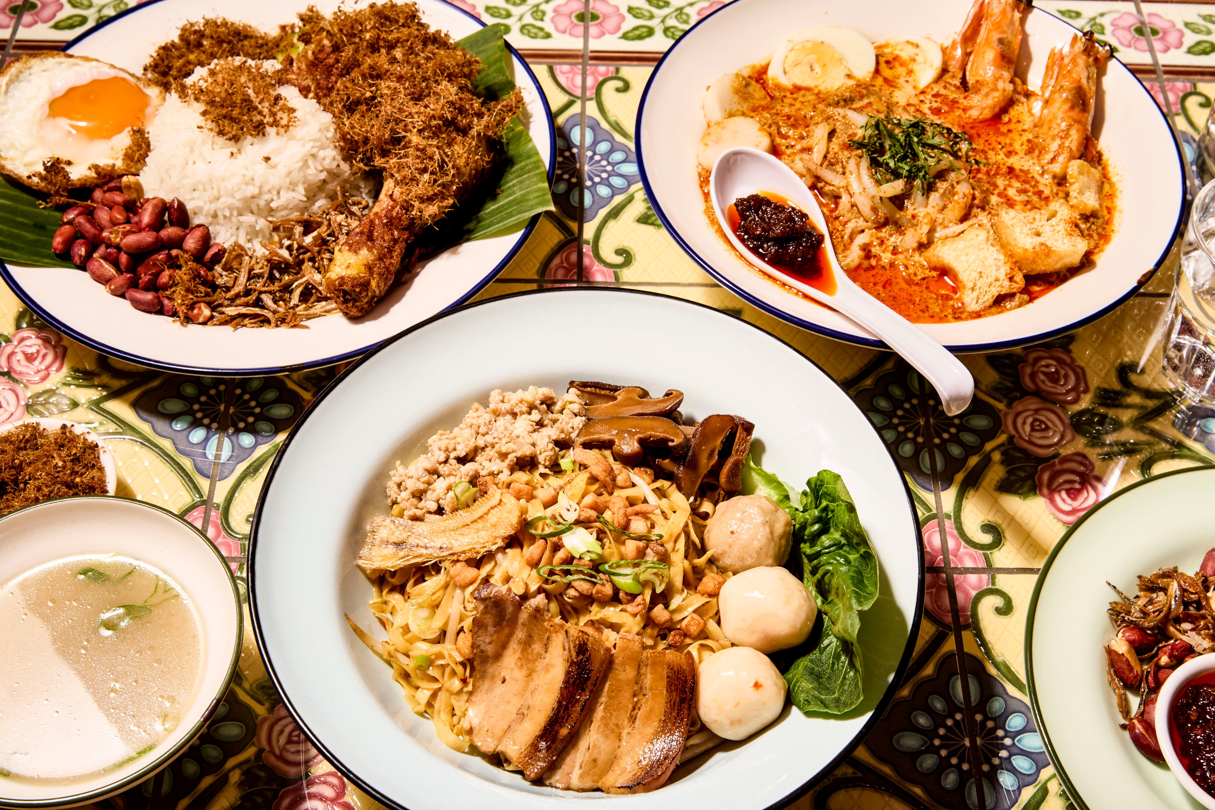 Singapulah, opened in Central London, serves traditional Singaporean dishes including bak chor mee (middle) and laksa (right). Photo: Singapulah