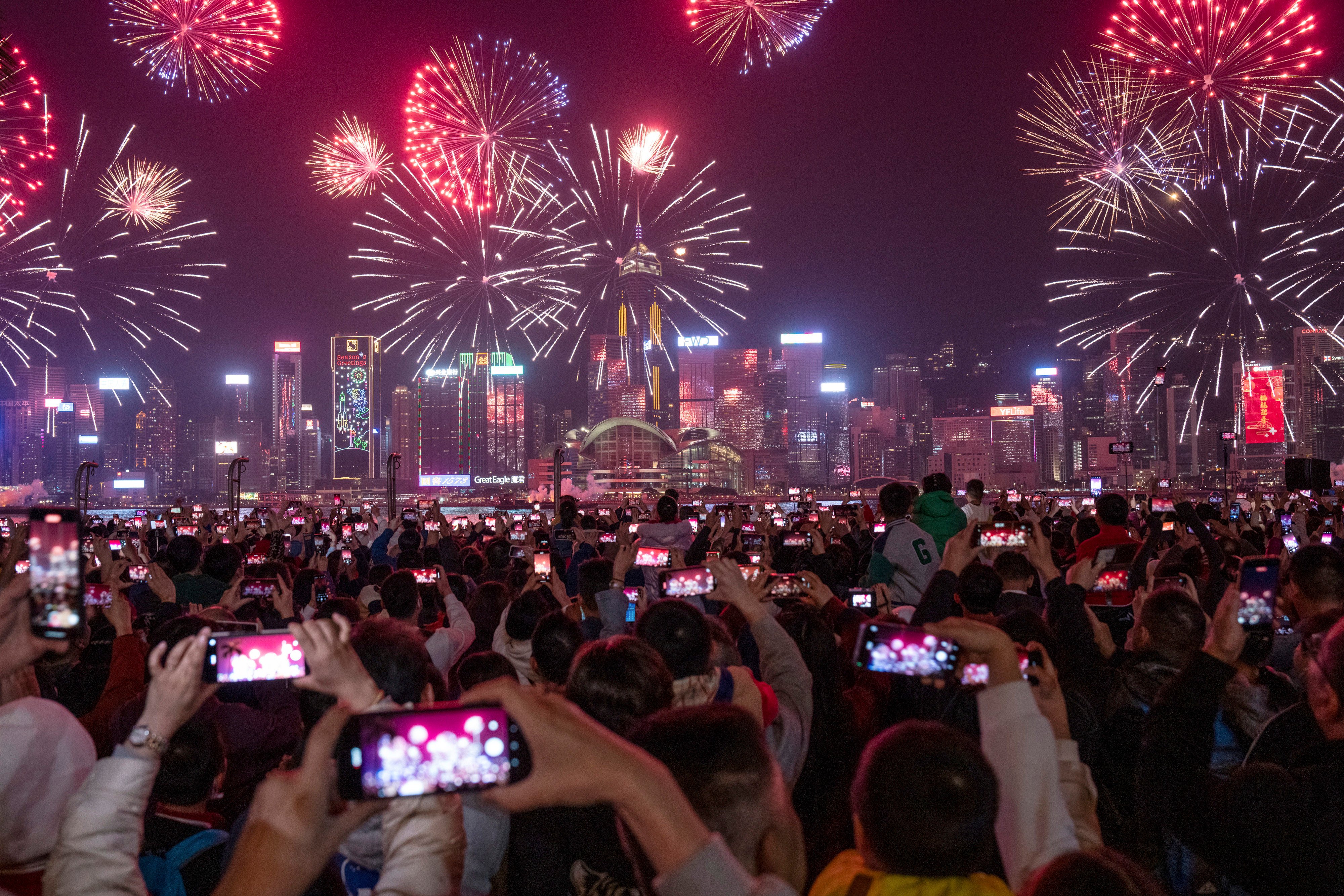 A crowd watches fireworks lighting up over Victoria Harbour on the second day of Lunar New Year on February 11. Photo: AP 