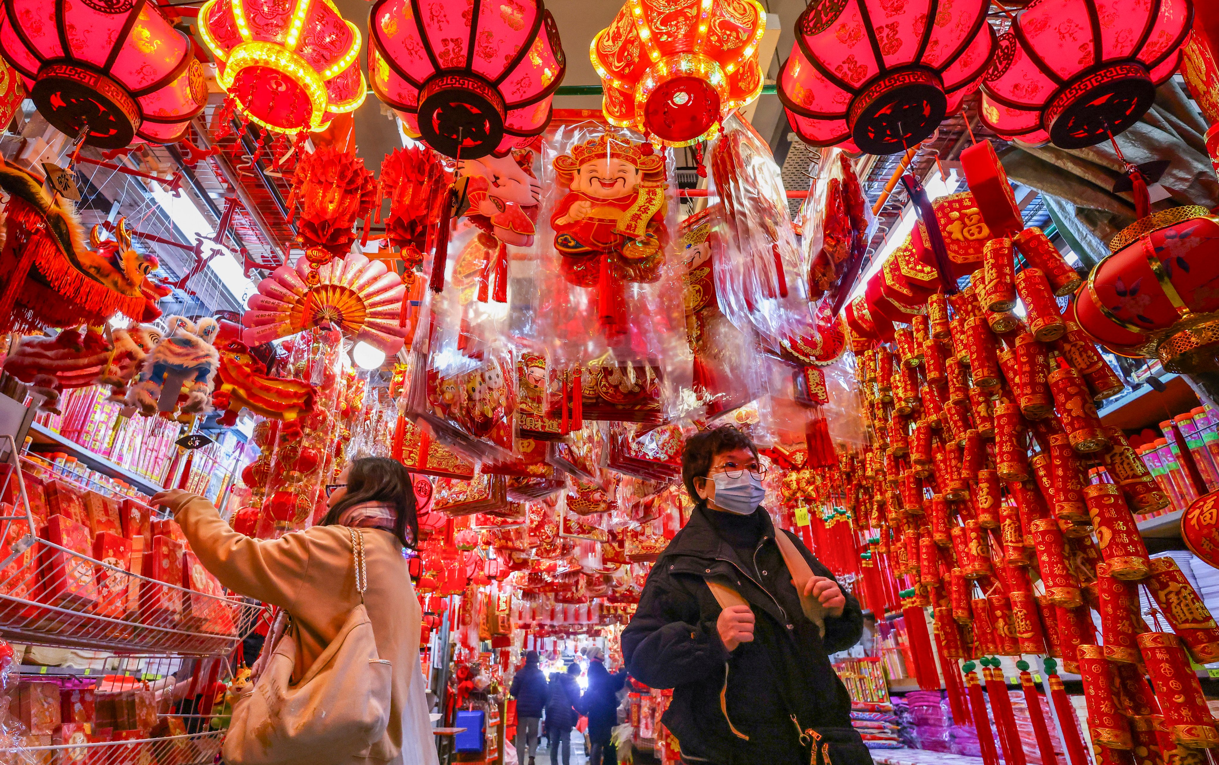 Shoppers  select Lunar New Year decorations and red packets amid a sea of festive ornaments at Tai Kiu market in Yuen Long on January 28. Photo: Dickson Lee