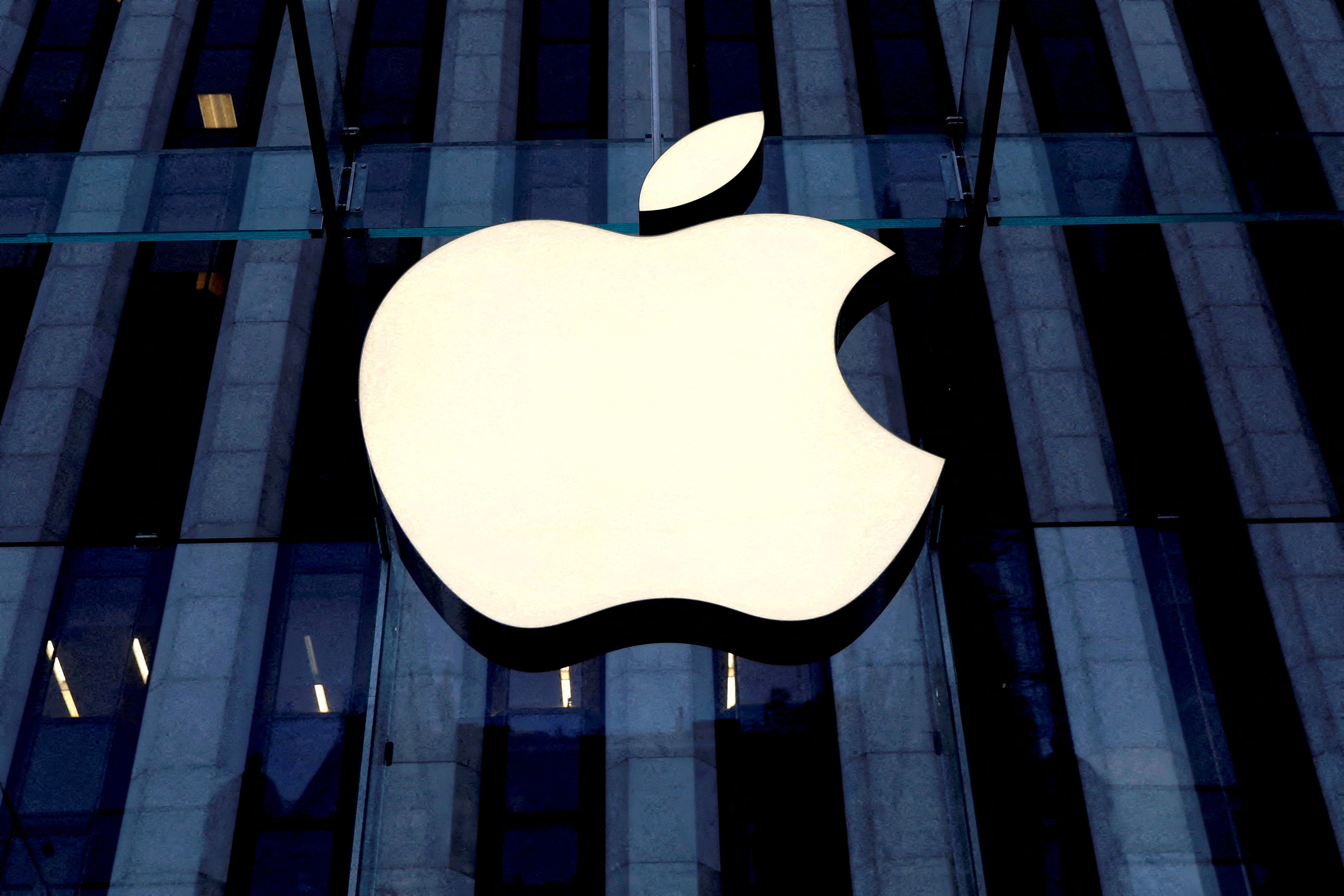 The Apple logo is seen hanging at the entrance to the company's retail store on 5th Avenue in Manhattan, New York, on October 16, 2019. Photo: Reuters