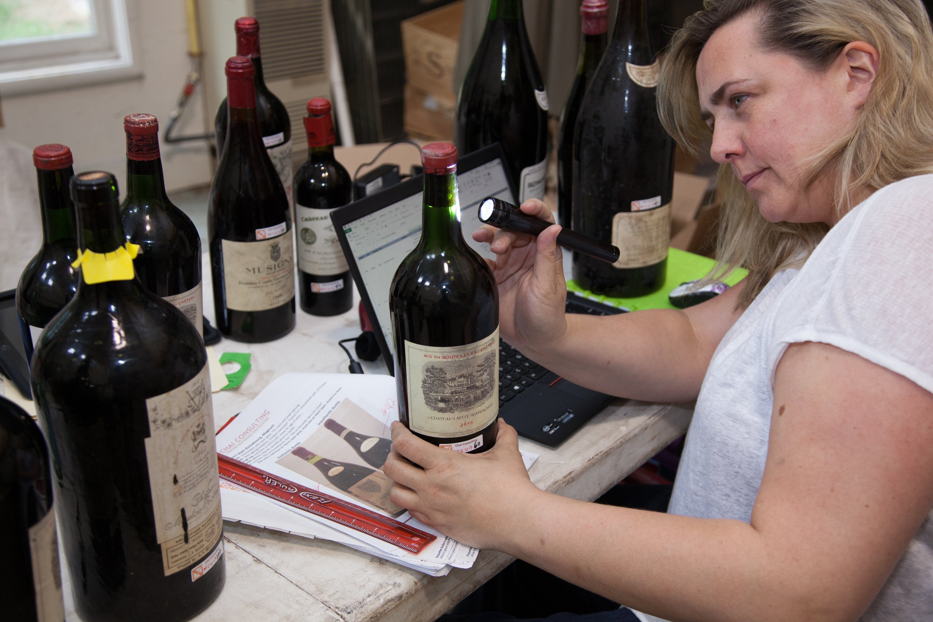 Maureen Downey looking a bottles of wine. Downey is a self-educated wine expert and fraud detector. Photo: Maureen Downey