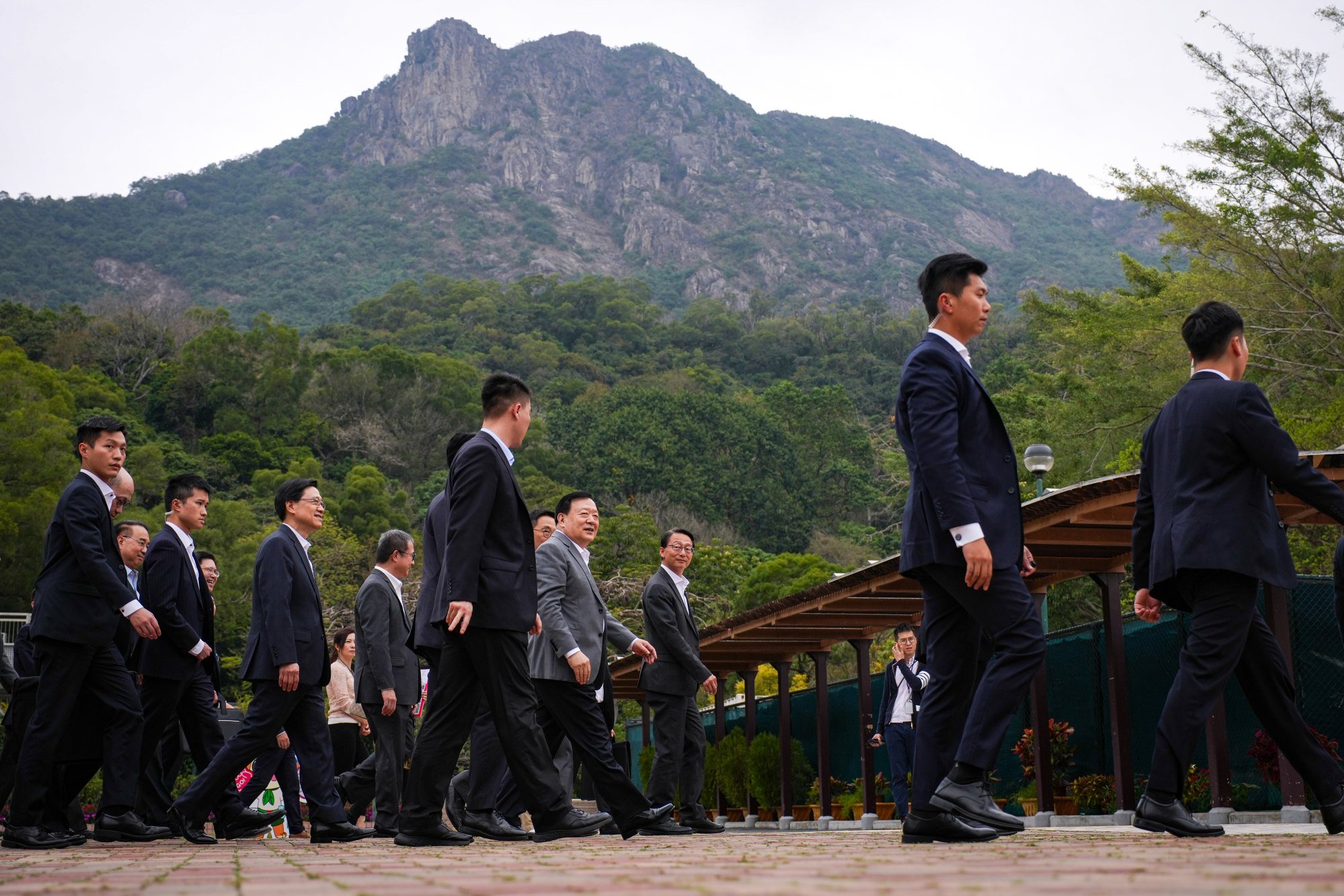 Xia Baolong enjoys a tour of Lion Rock Park with other officials. Photo: Eugene Lee