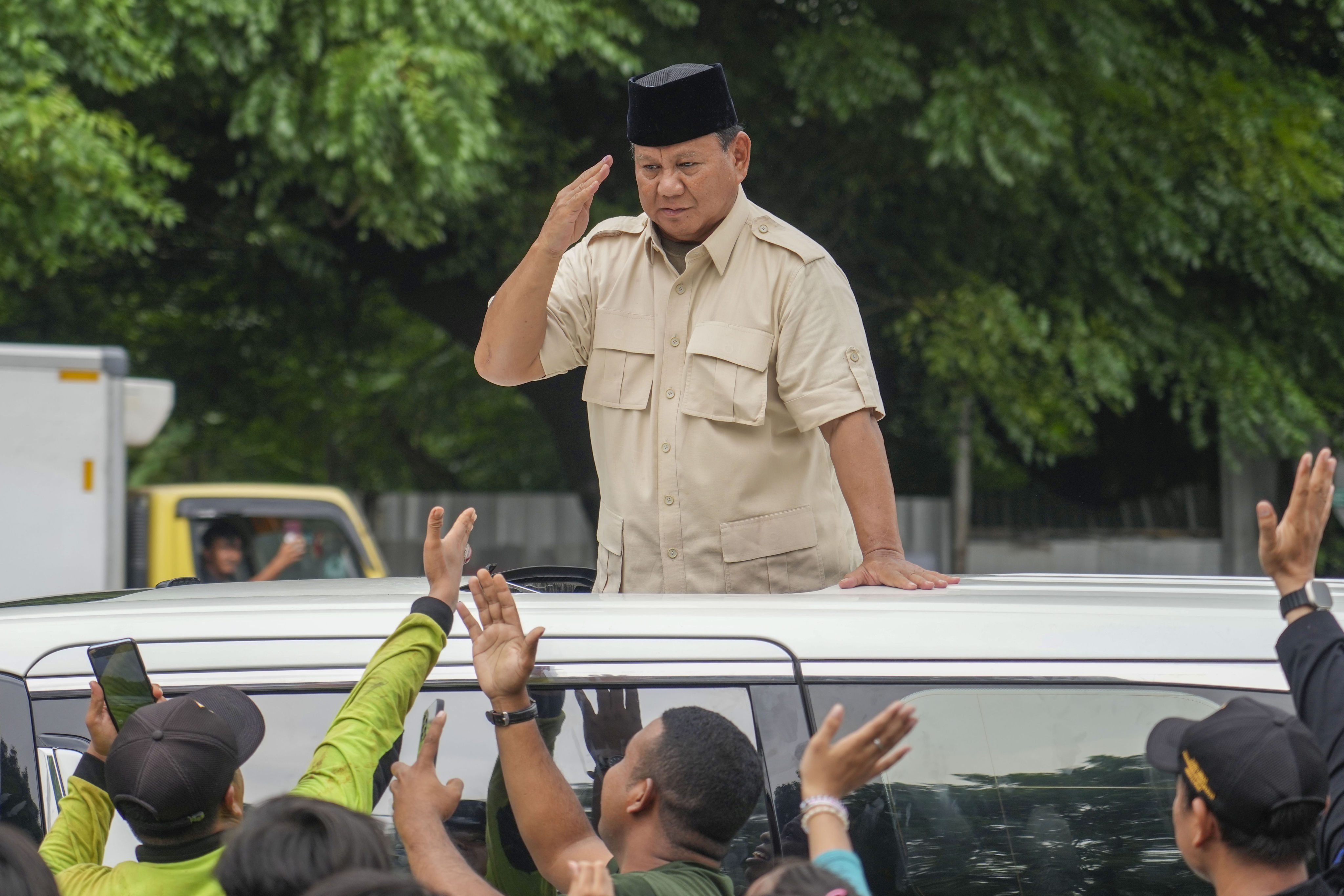 Indonesian Defence Minister and presidential frontrunner Prabowo Subianto greets supporters after visiting his father’s grave in Jakarta on February 15. Photo: AP