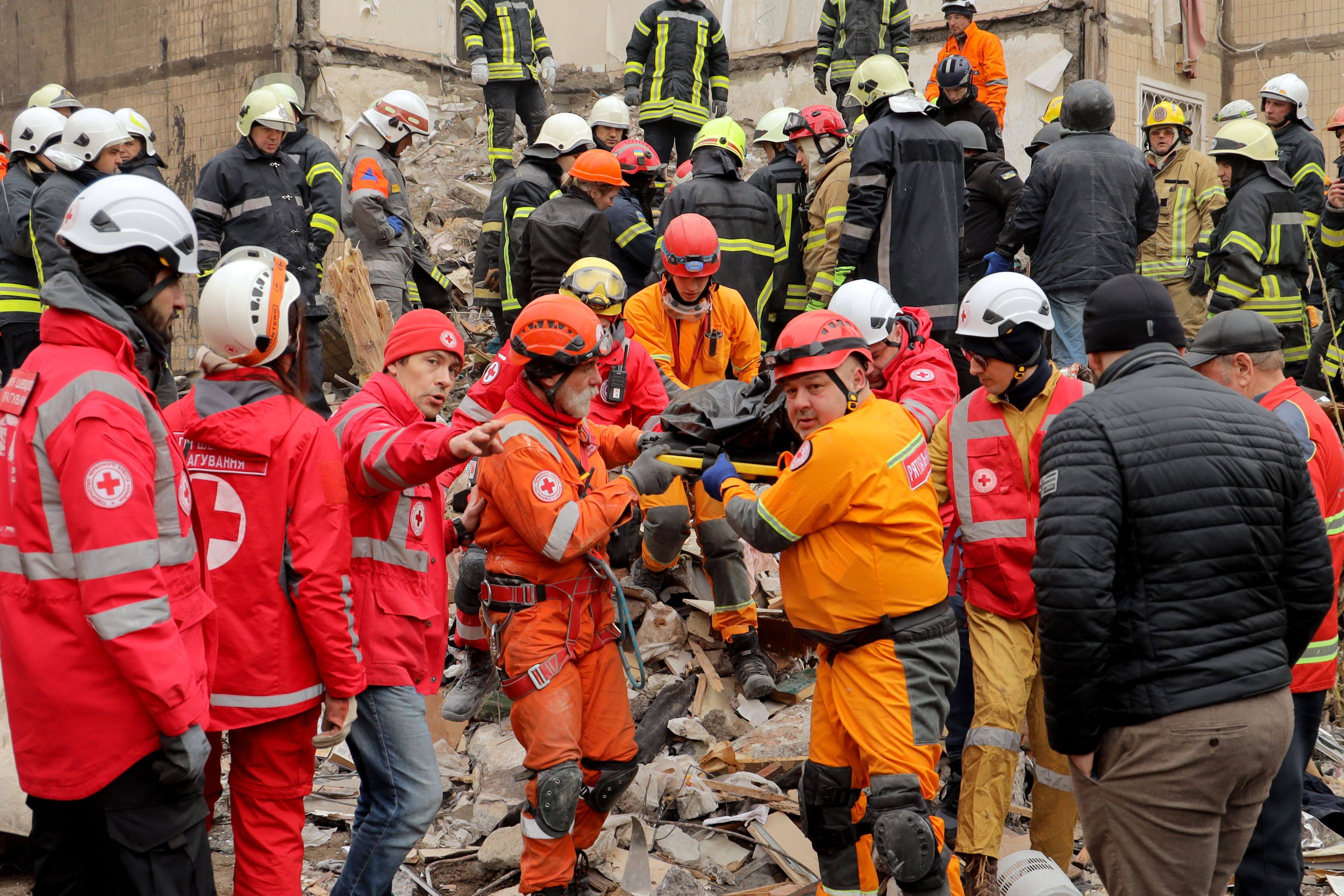 Rescuers in Odesa carry a body on Saturday at the site of a heavily damaged apartment building, following a Russian drone attack. Photo: AFP