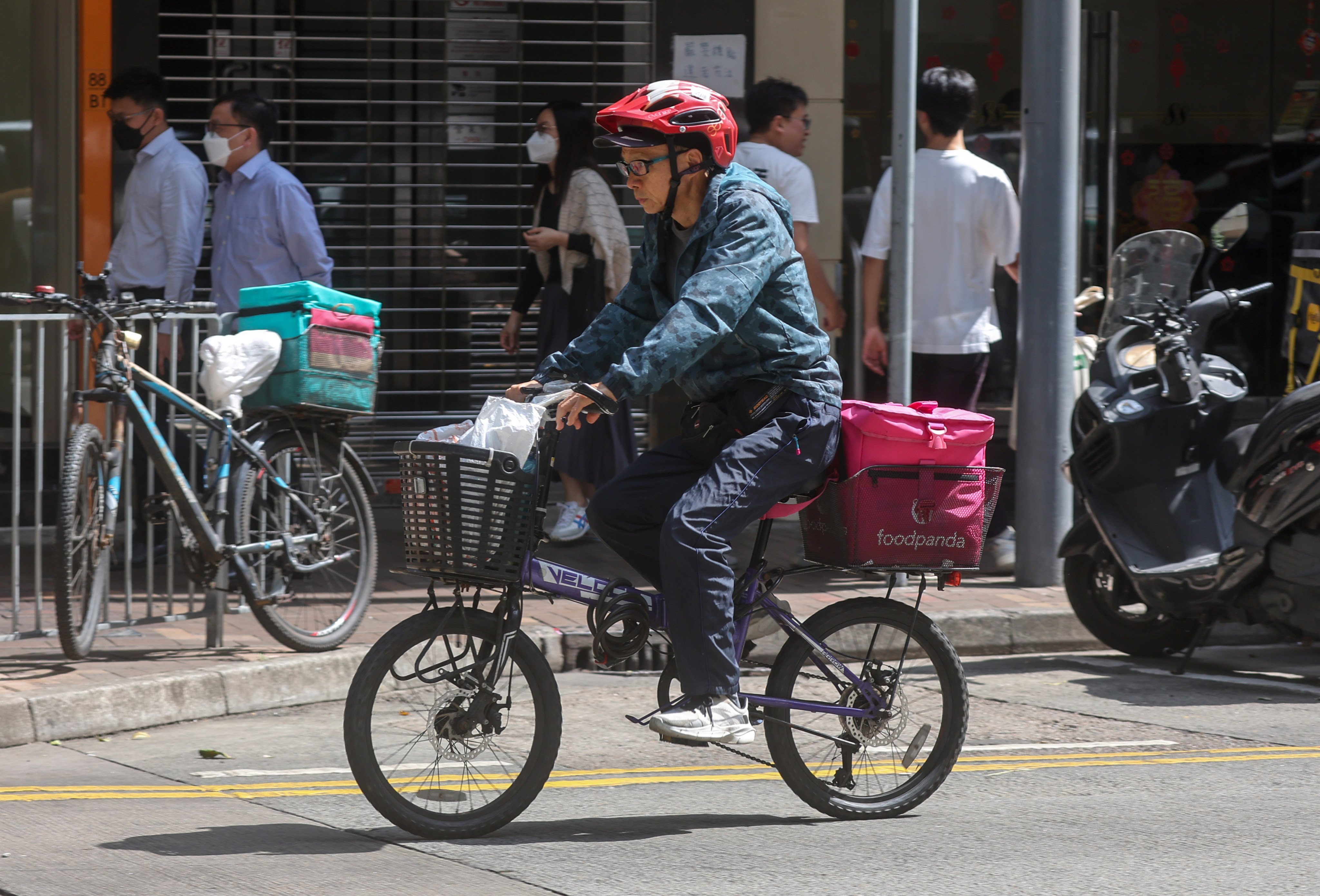 A food delivery worker in Wan Chai. Over 500 riders refused to do deliveries during the lunchtime peak period on February 26. Photo: Edmond So
