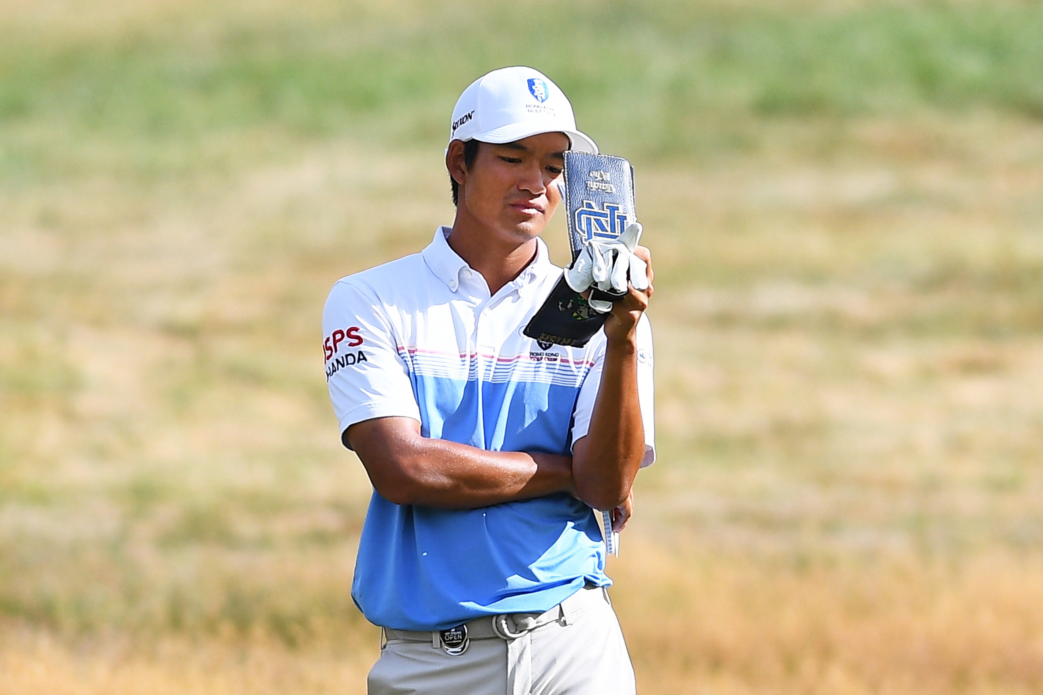 Taichi Kho studies his yardage book during the third round of the New Zealand Open. Photo: Asian Tour