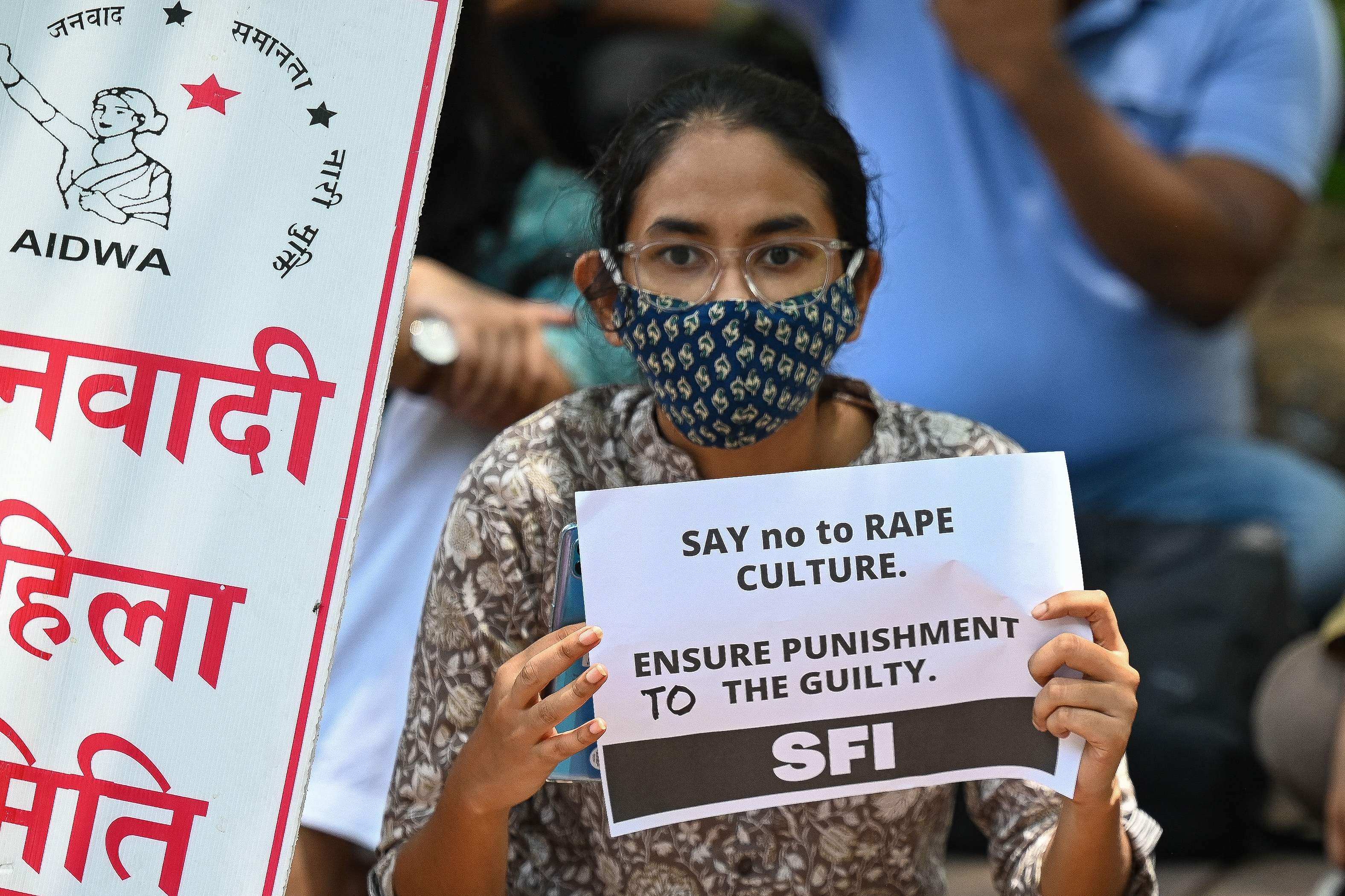 An activist holds a placard during a protest against the rape and murder of a nine-year-old girl in New Delhi in 2021. Photo: AFP