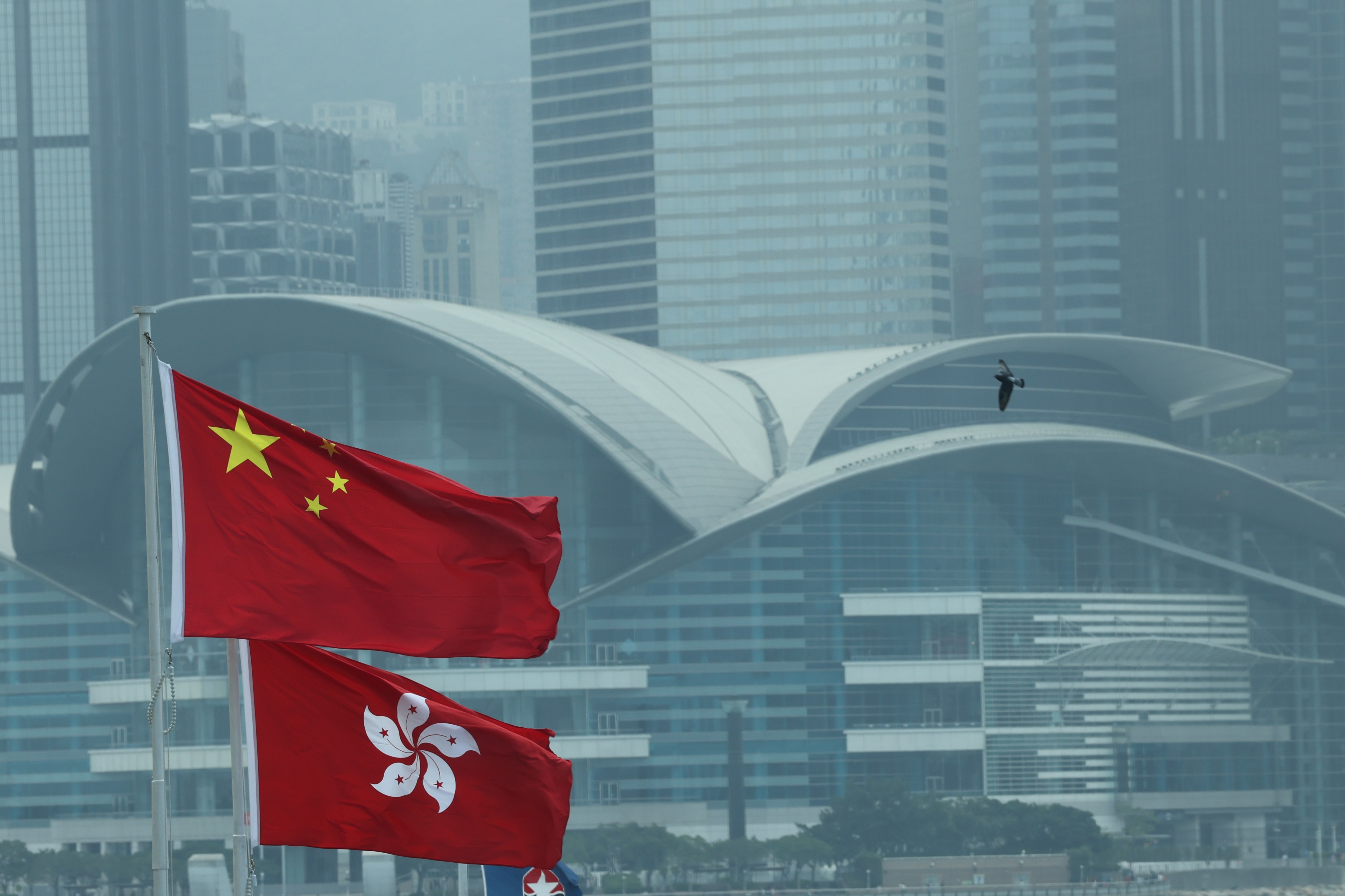 The Chinese flag and the flag of the HKSAR fly outside the Hong Kong Convention and Exhibition Centre. Photo: Jelly Tse