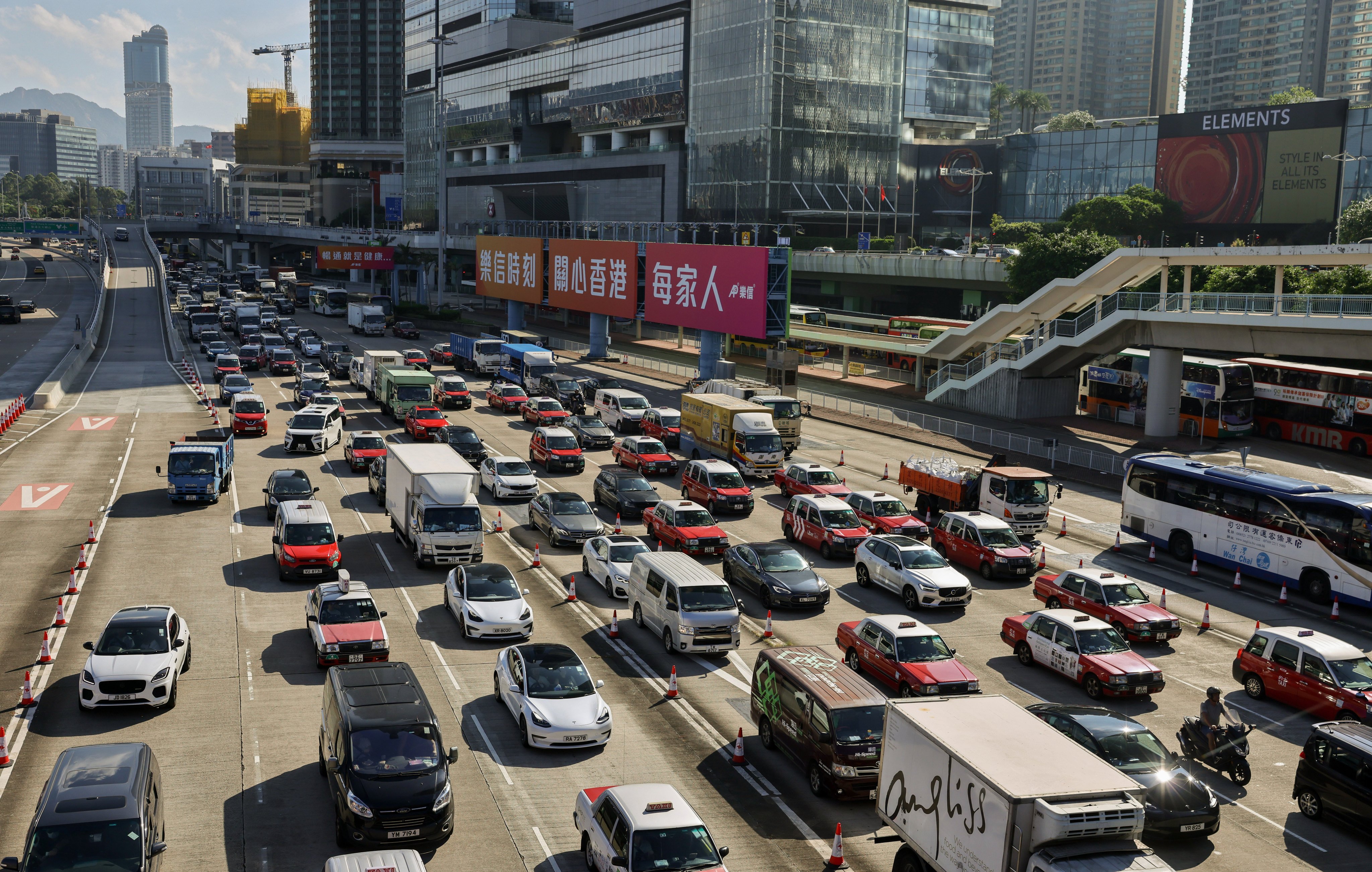 Vehicles heading to a cross-harbour tunnel. Wealthy buyers of top-end EVs are unlikely to be deterred by the reduced tax breaks, industry players say. Photo: May Tse