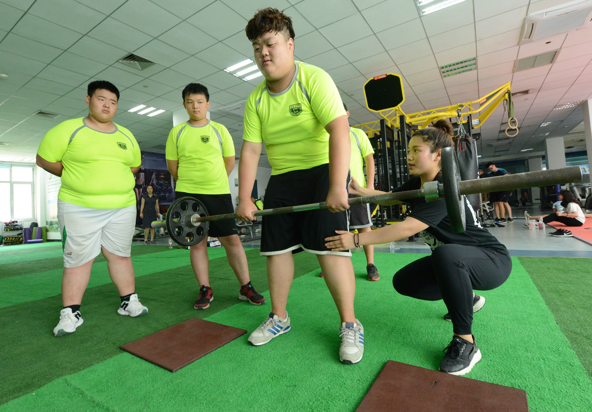 Obese Chinese boys exercise with a coach at a summer camp in Zhengzhou, Henan, in July 2017. Summer camps have sprouted up across the country in recent years to help fat children lose weight. Photo: Visual China Group via Getty Images