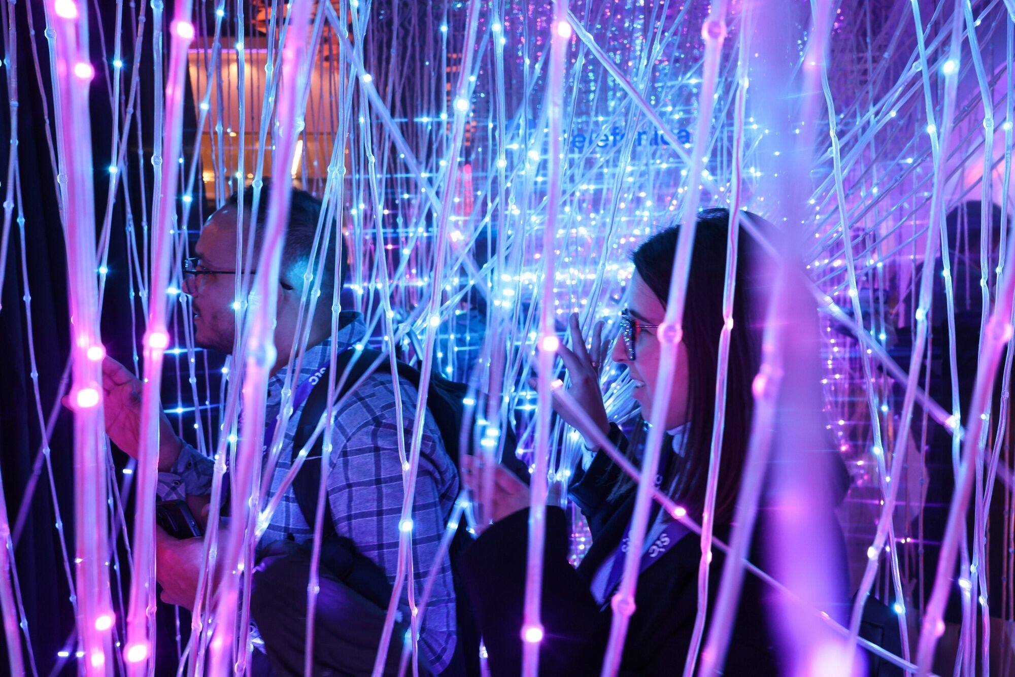 People walk through a display of fibre optic cables at the Mobile World Congress in Barcelona on February 26. As a result of the dotcom bubble of the late 1990s, more than 128 million km of fibre optic cable was installed in the US. Photo: Bloomberg
