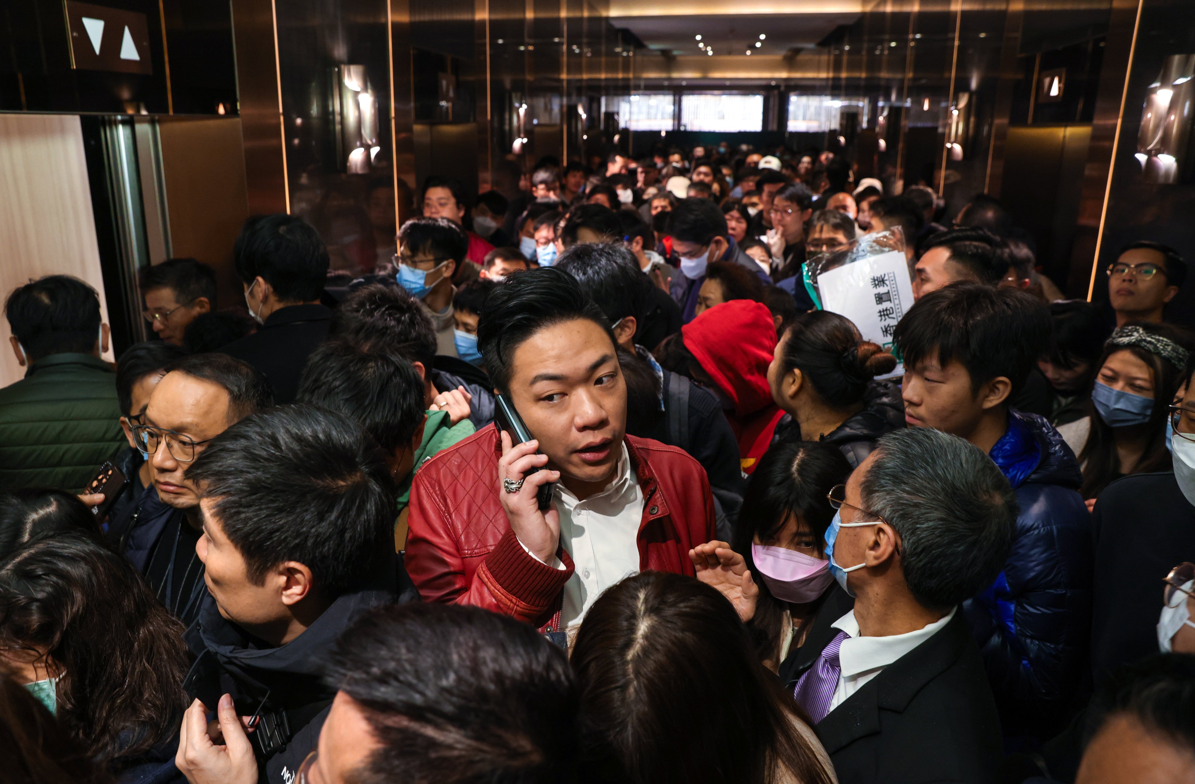 Potential homebuyers line up for Henderson Land’s Belgravia Place residential project at the sales office in Tsim Sha Tsui on Sunday. Photo: Yik Yeung-man