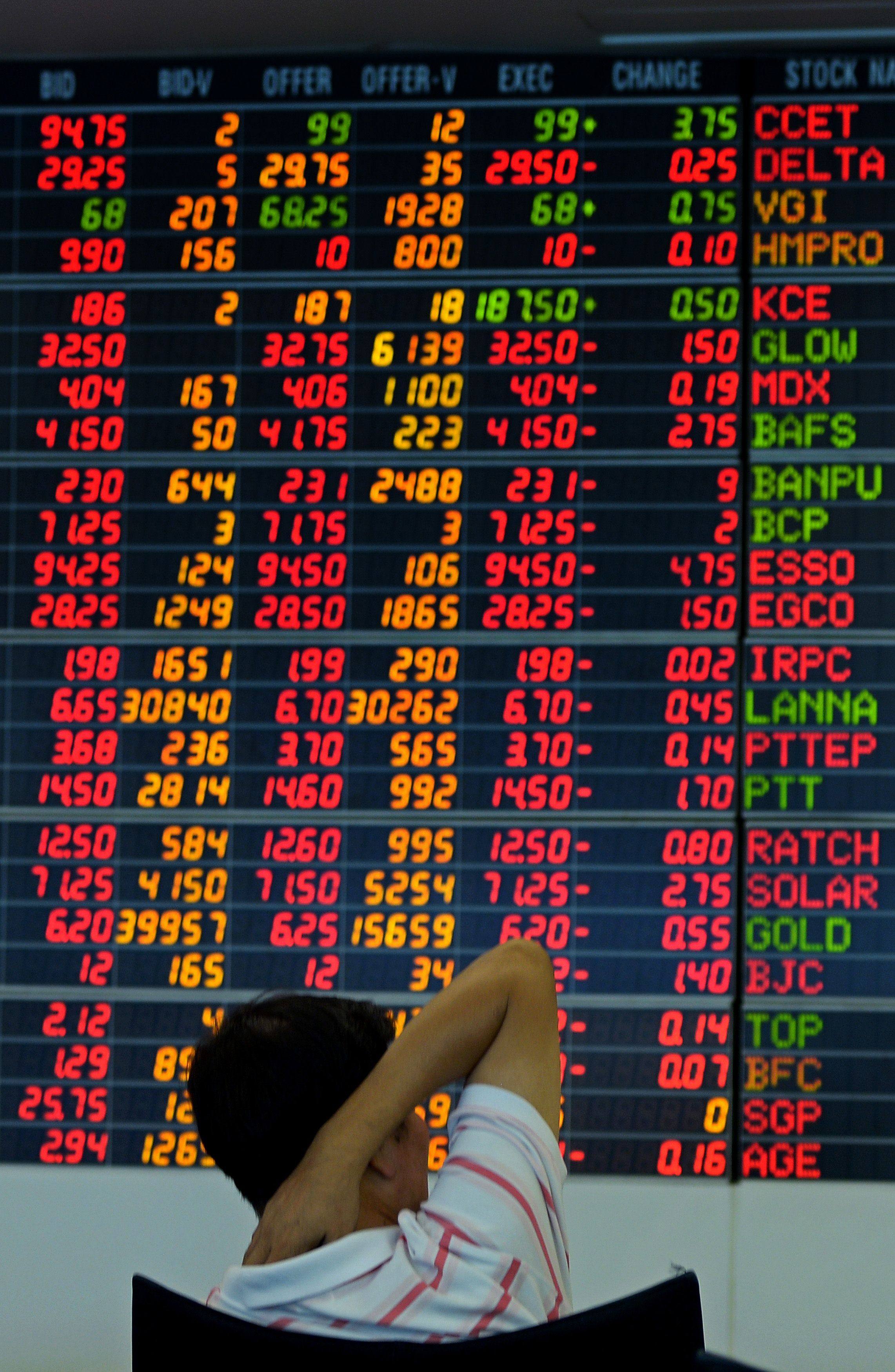 A Thai investor looks at an electronic display of share prices at a private trading company in Bangkok. Photo: AFP