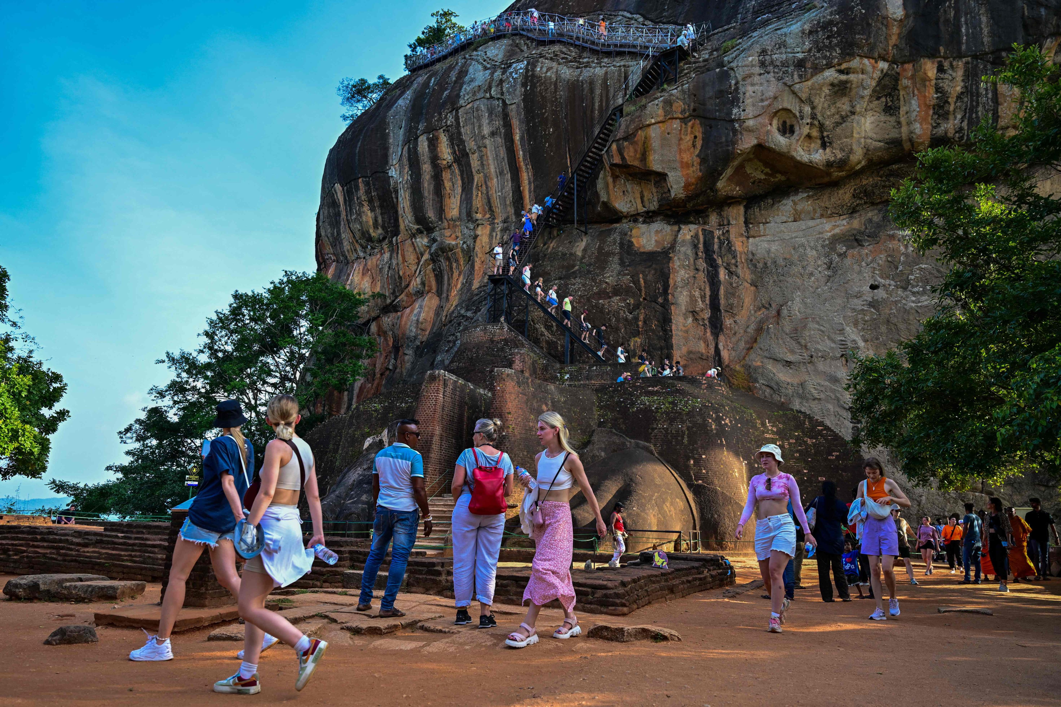 Foreign tourists visit an ancient rock fortress in Sigiriya, Sri Lanka, last month. Photo: AFP