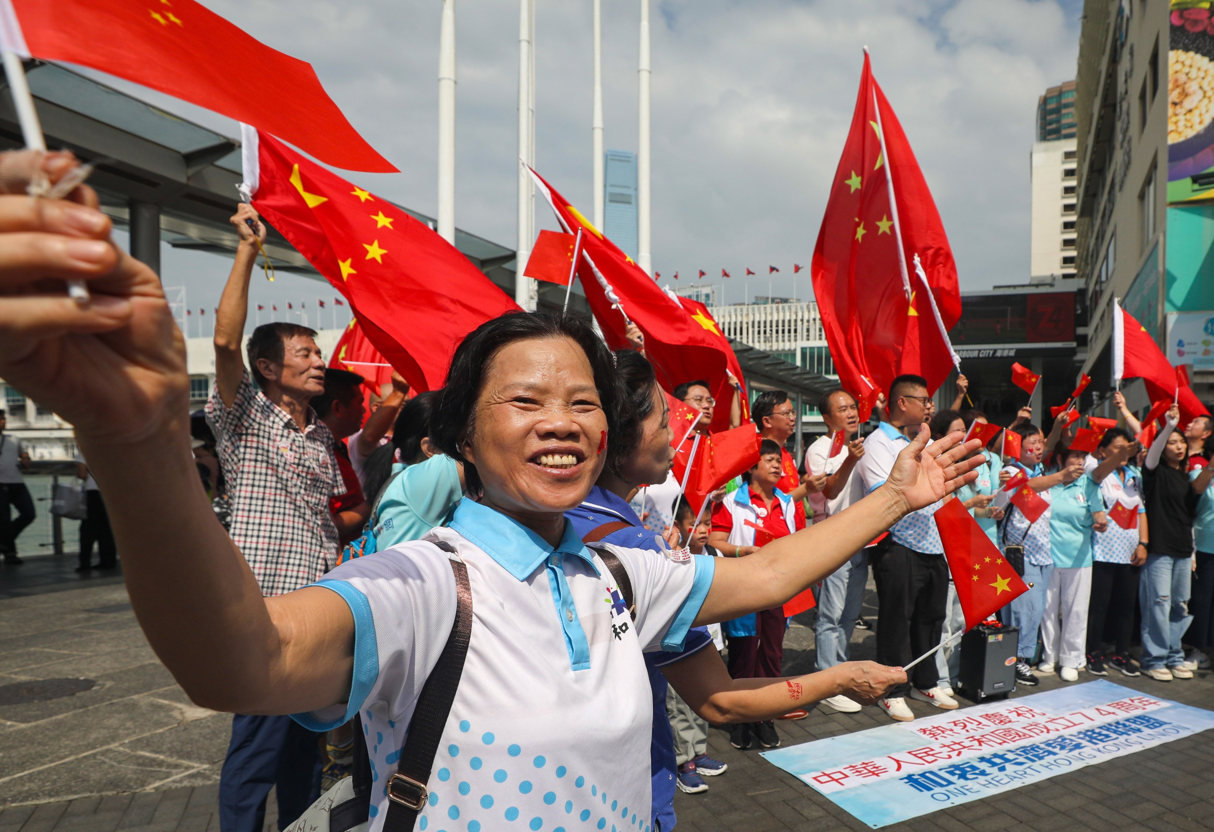 People wave Chinese flags in Tsim Sha Tsui on National Day last year. The Social Welfare Department has not revealed the weighting of new criteria for in a scoring system for funding allocation. Photo: Xiaomei Chen