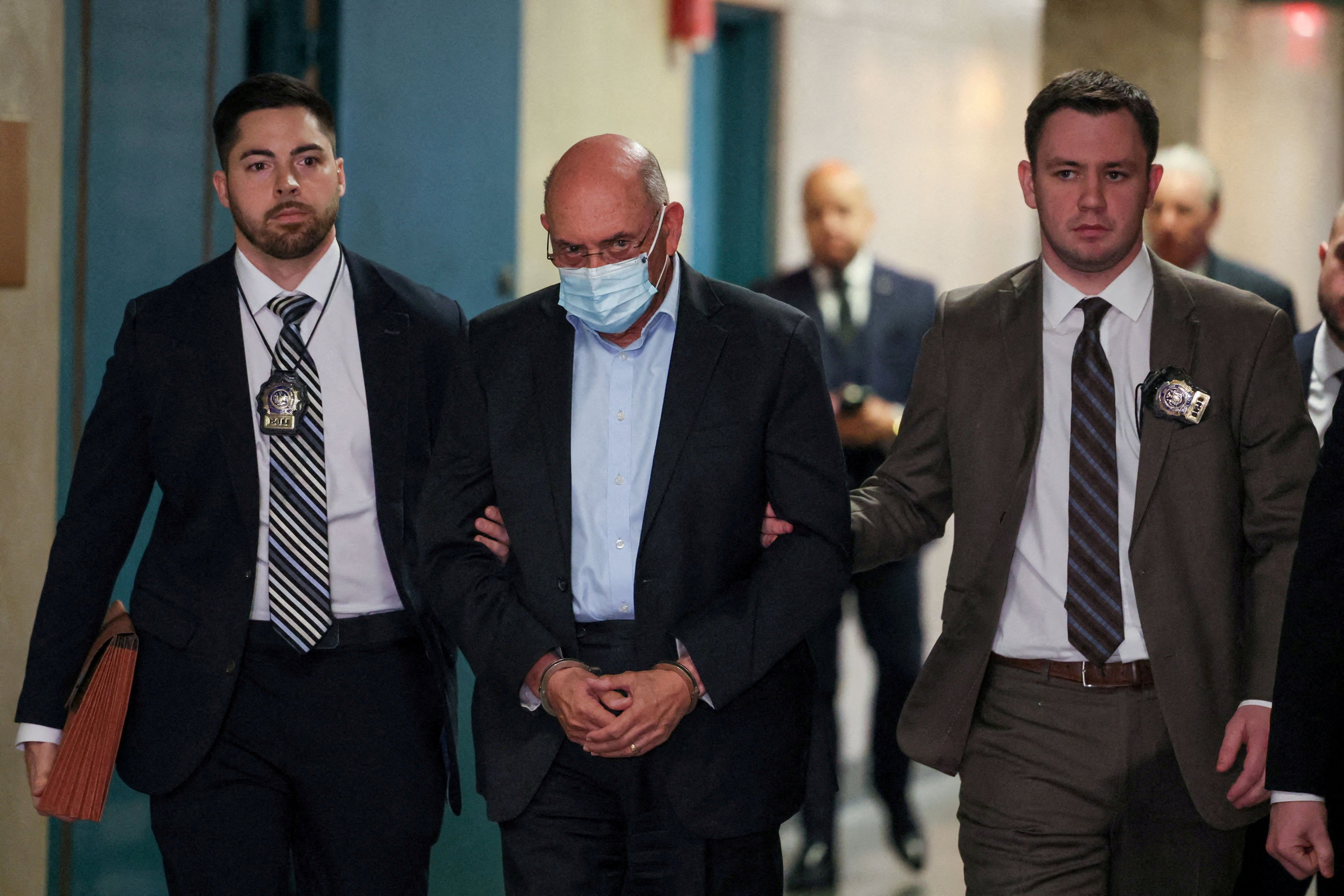 Allen Weisselberg walks handcuffed at Manhattan Criminal Court in New York City. Photo: Reuters