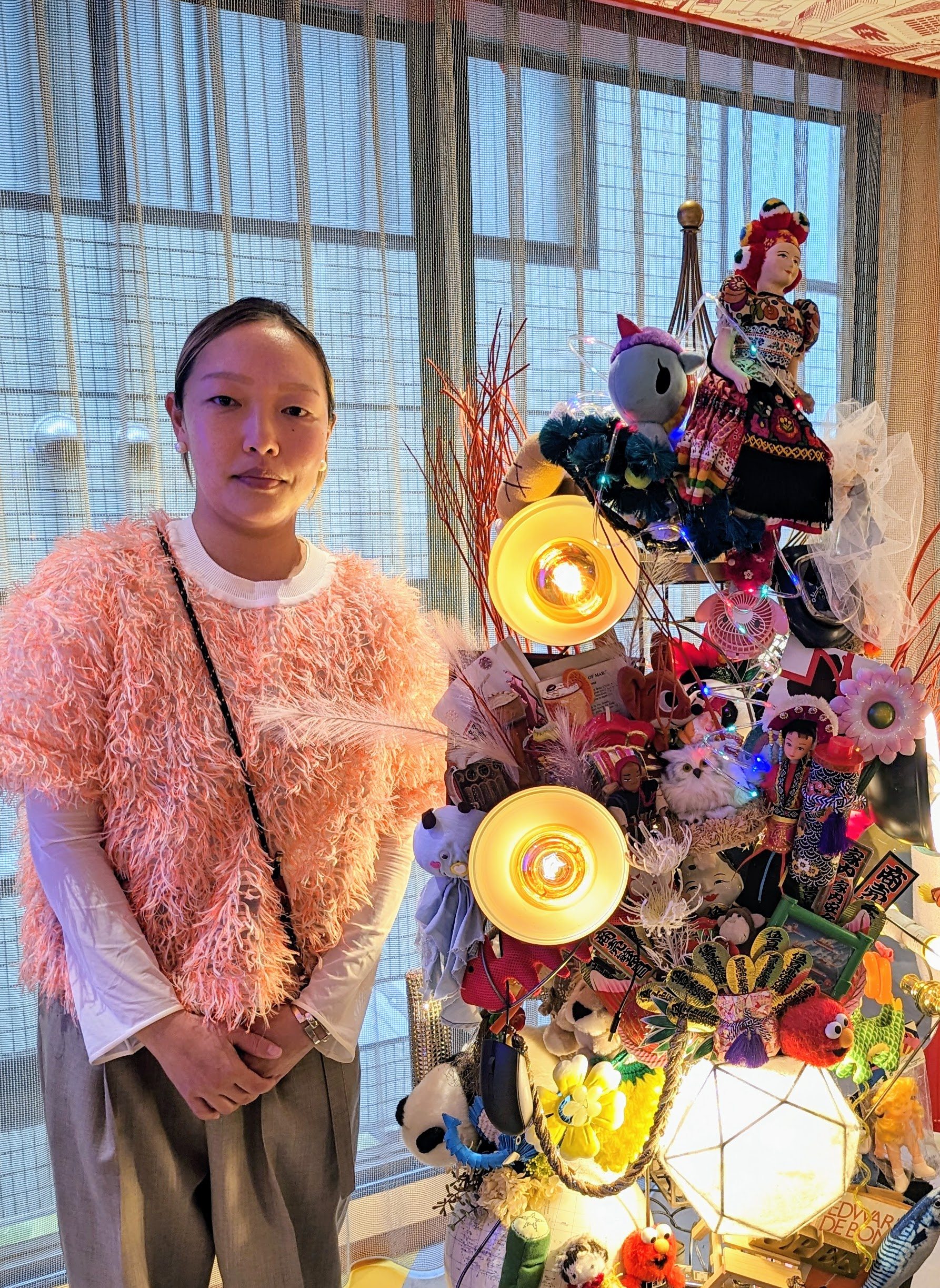 Songhe Kim and her standing chandelier, made from dolls and other discarded items, in the lobby of Lyf Ginza Tokyo, a co-living space in Ginza in the Japanese c capital. Photo: Lisa Cam